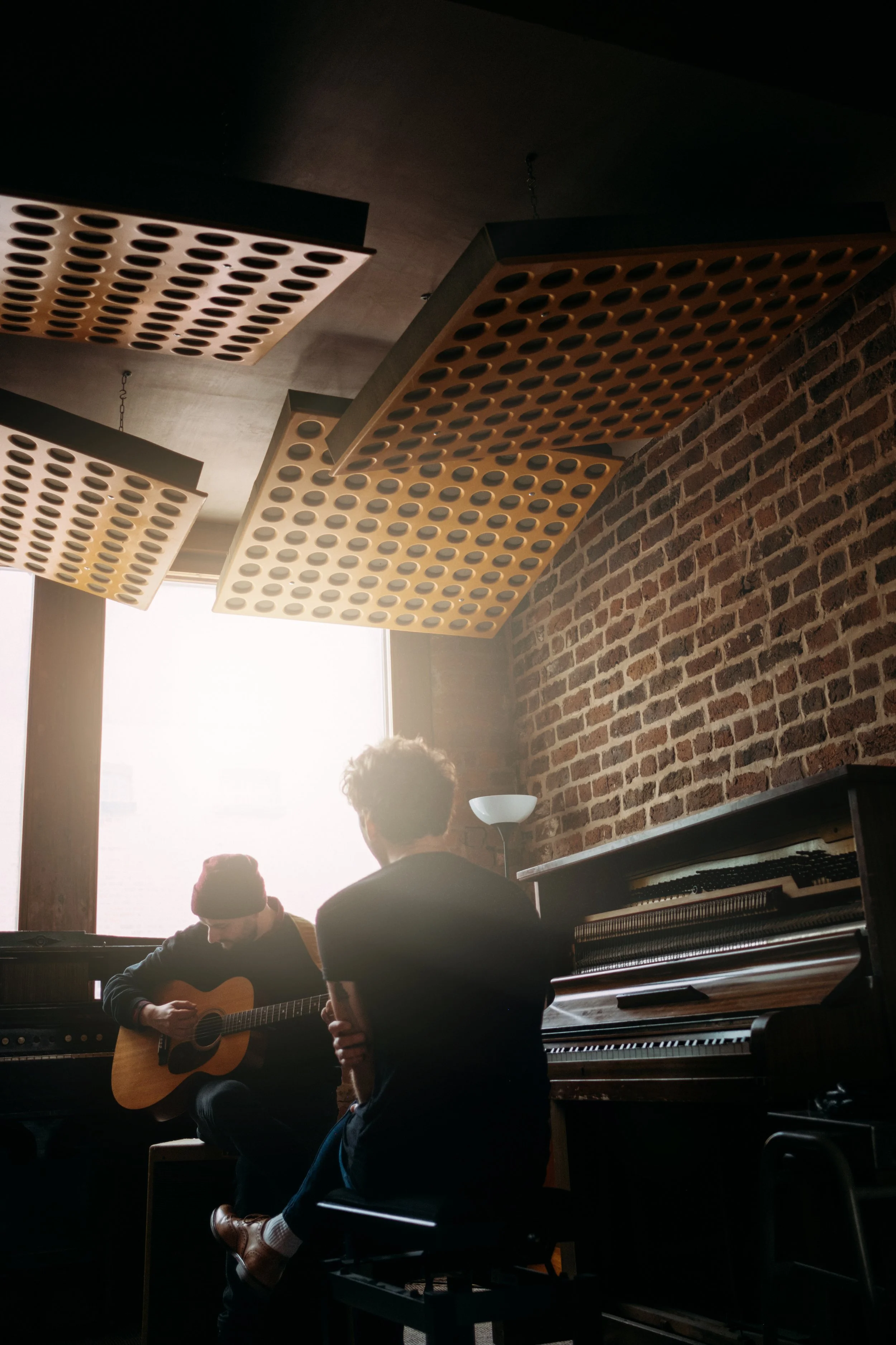 Musician silhouetted against backlight — atmospheric music portrait photography