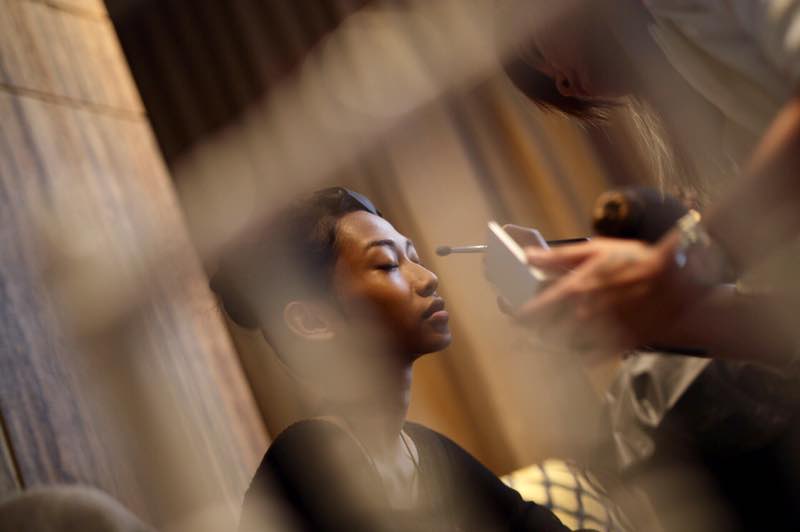 A model getting her makeup done by sponsor Qristina Lim Academy