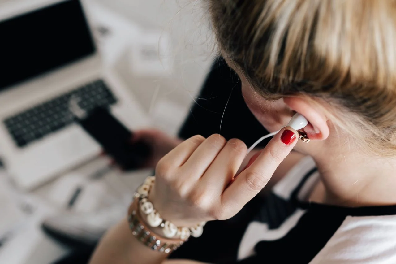 kaboompics_Woman listening to music with earphones.jpg