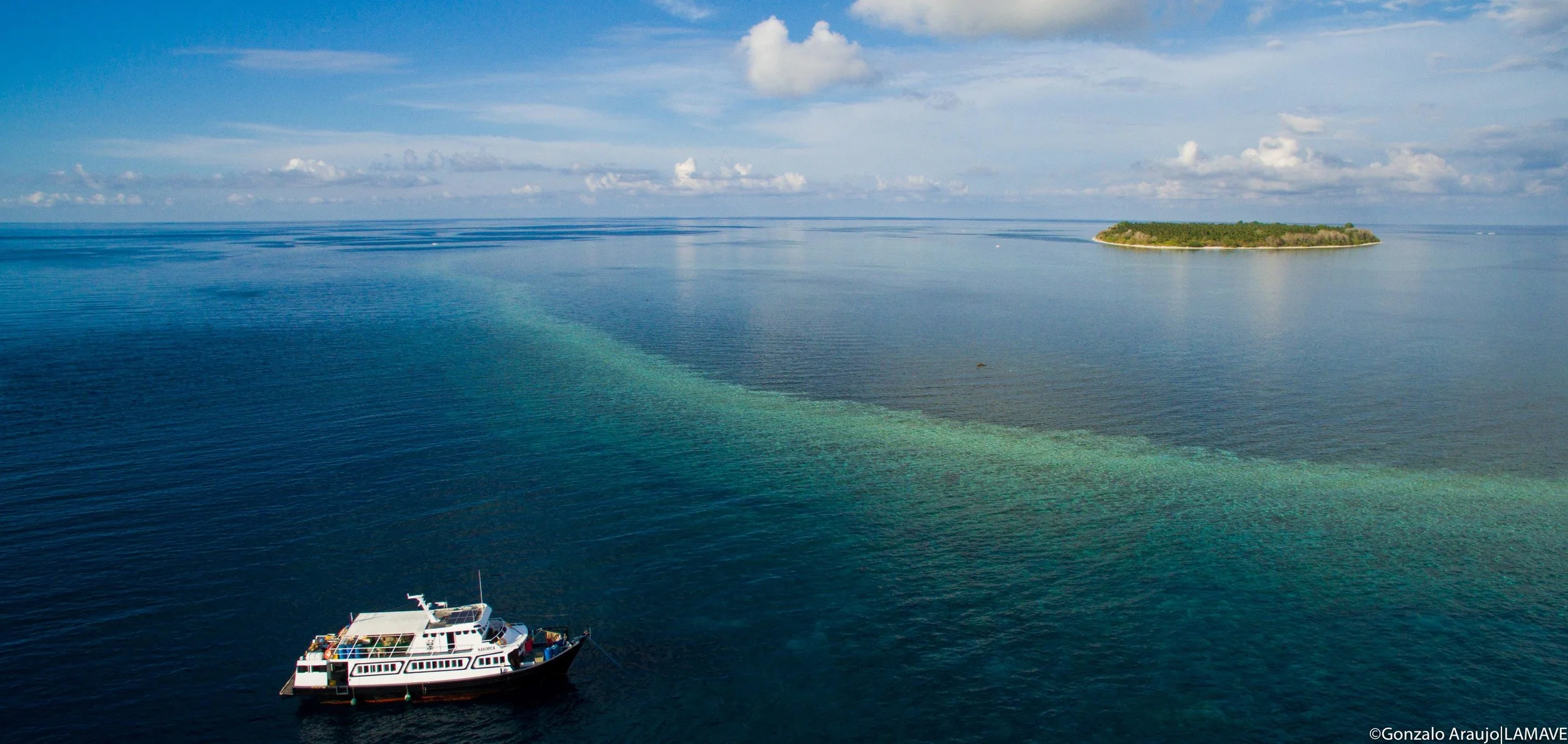 The research boat MY Navorca positioned off Cawili Island, Cagayancillo (Credit: Gonzalo Araujo|LAMAVE)