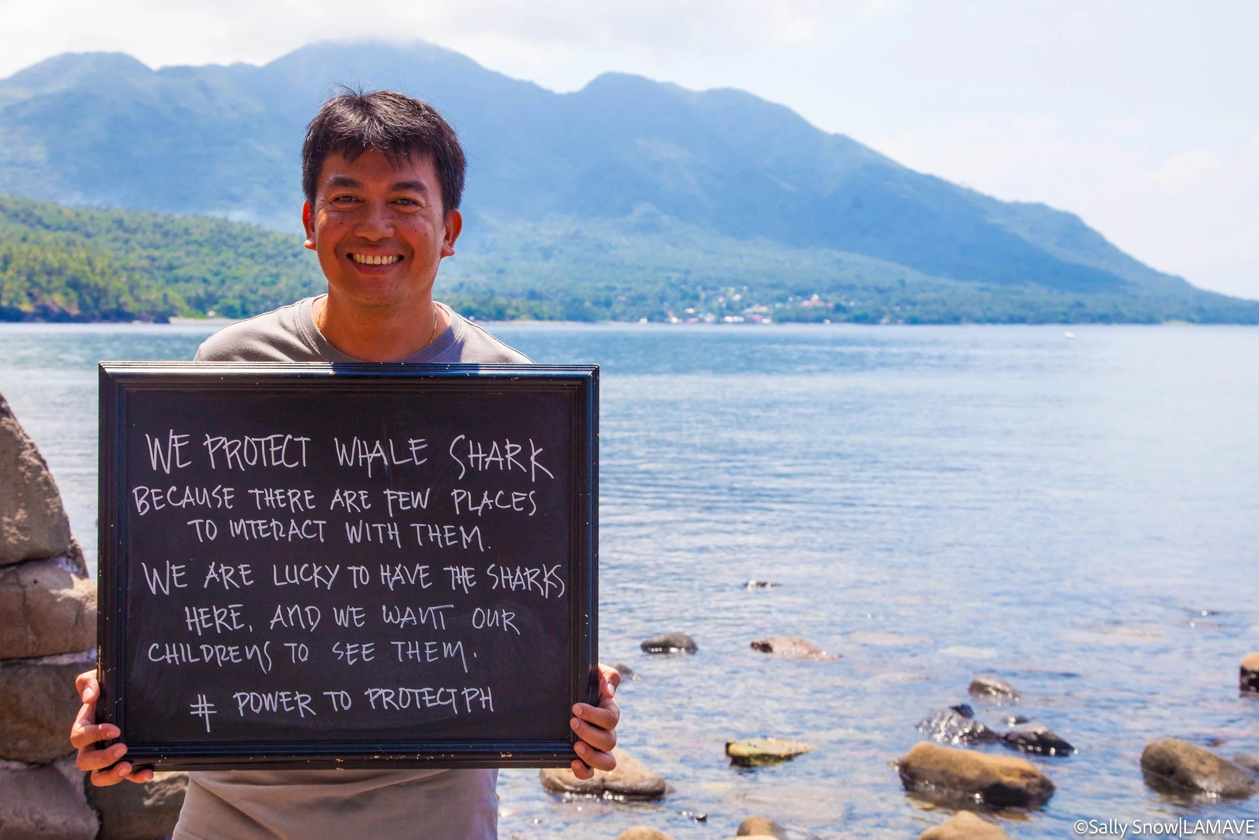 Sir Lito holds up a message as part of the Their Future Our Future campaign