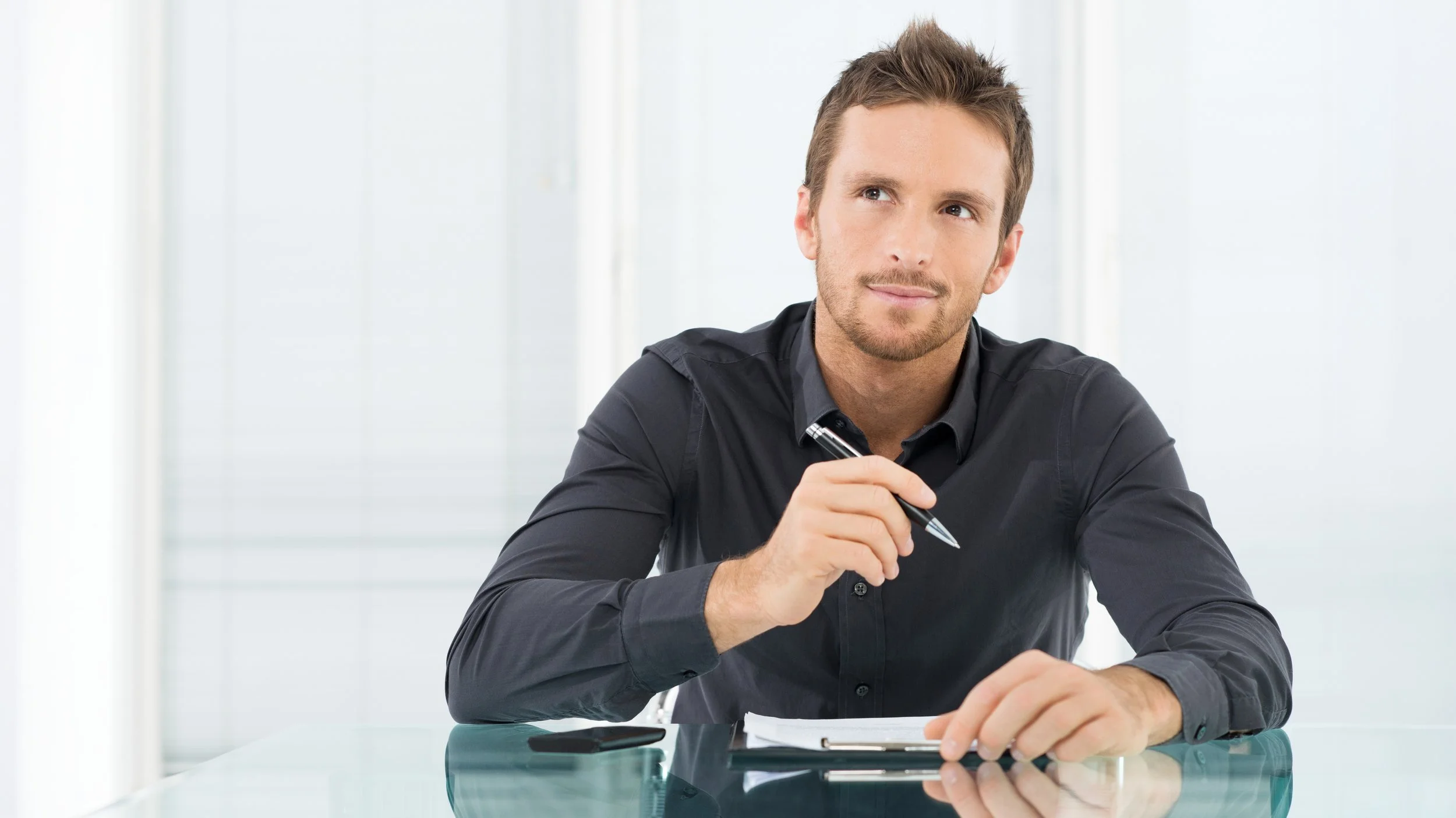 man thinking with pen widescreen.jpg