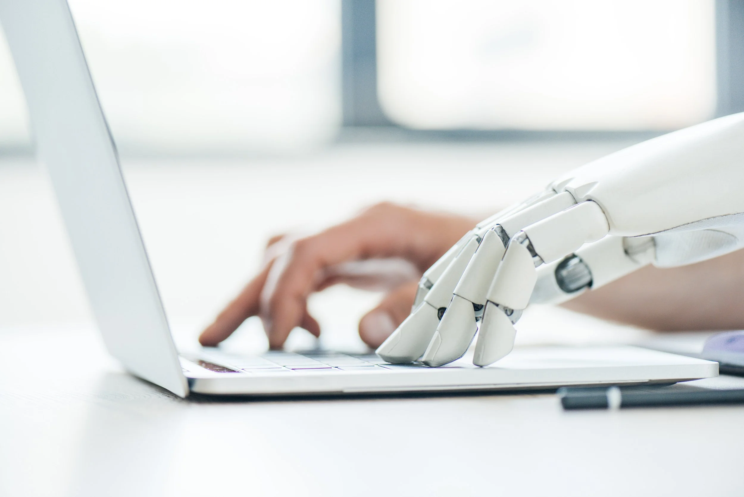 robot and human hands typing.jpg