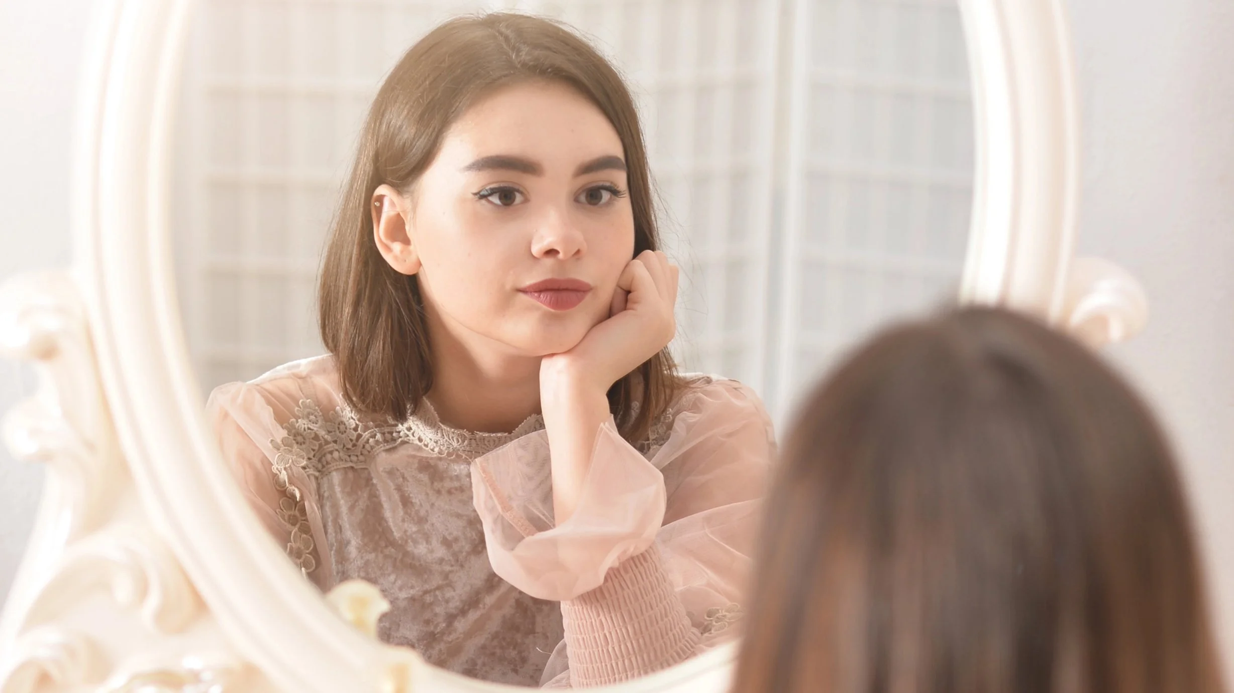 girl looking in mirror thinking widescreen.jpg