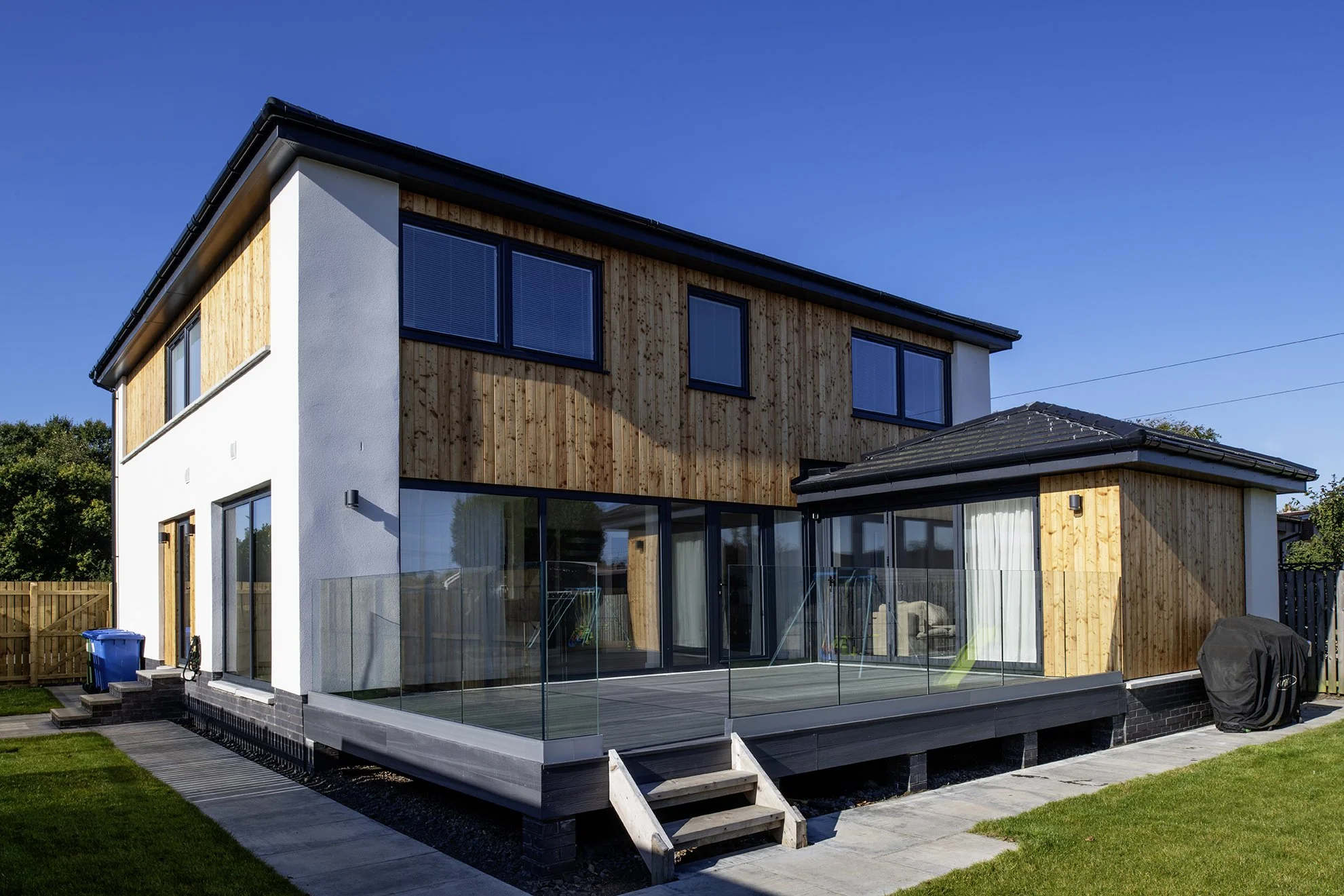 Extensive glazing opens onto a terrace and rear garden.