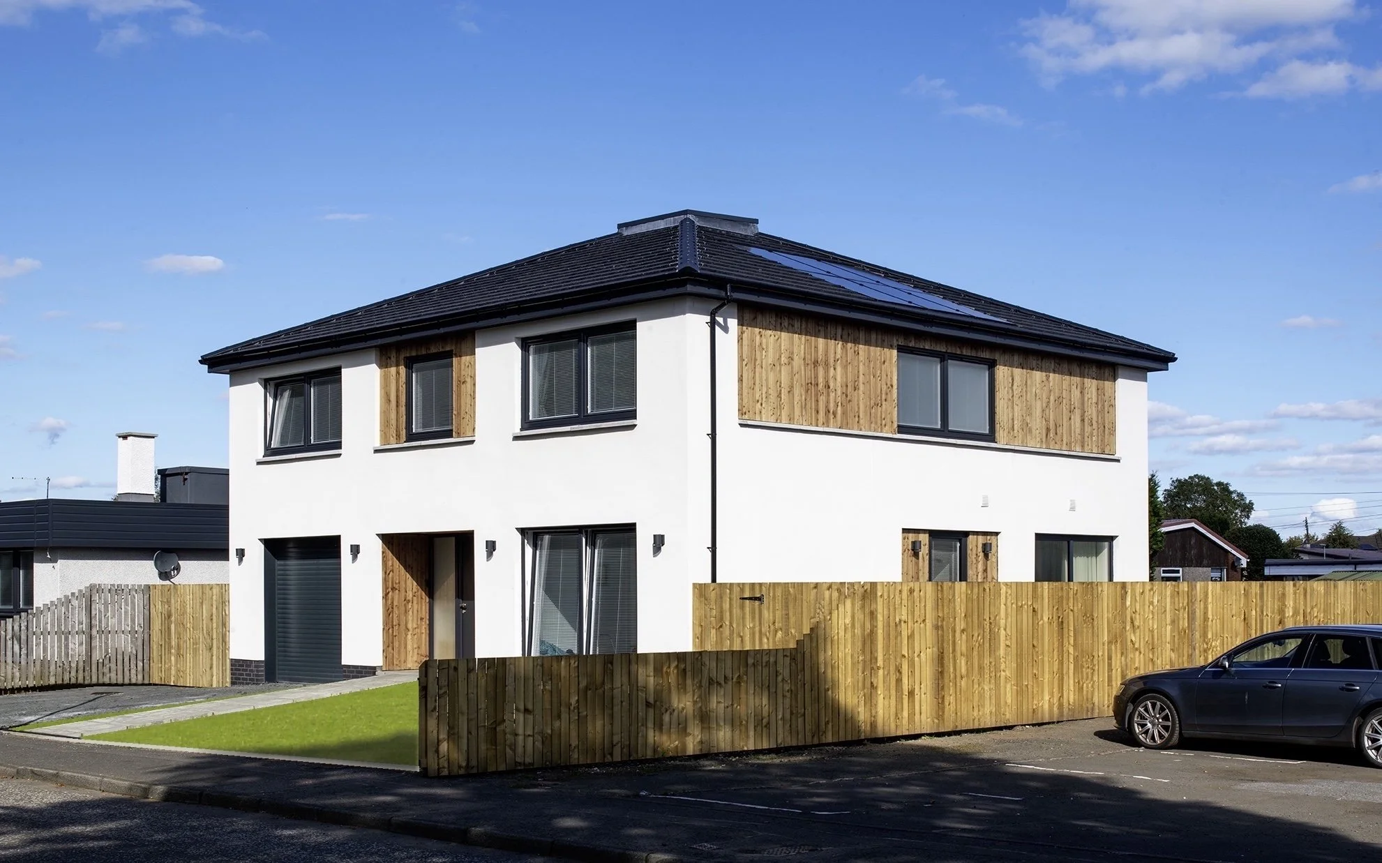 The square plan house is a strong simple design that sits well in a varied context.