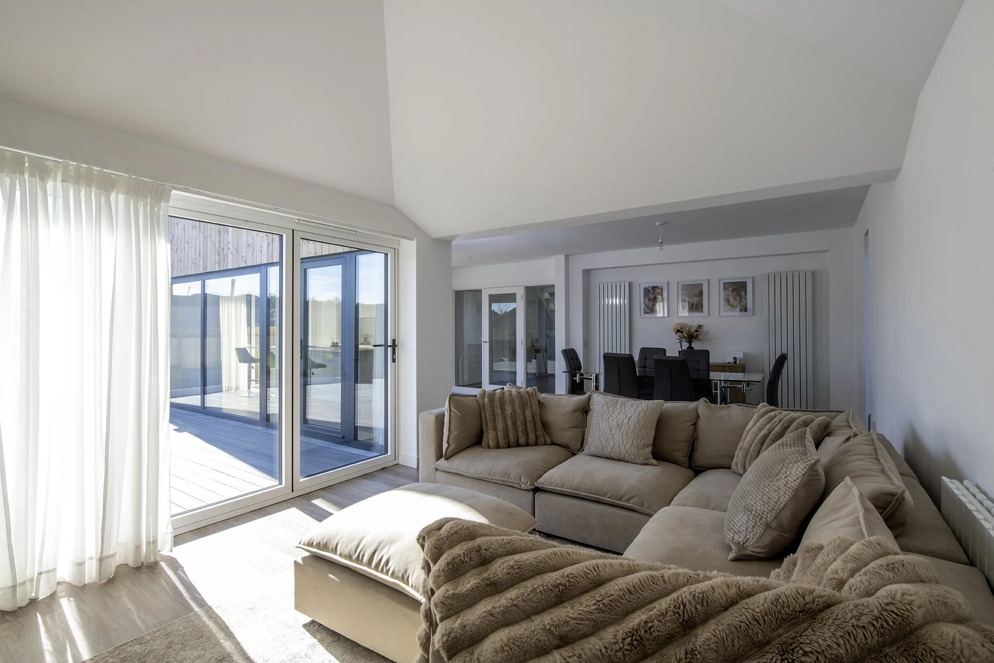 The open plan living - dining - kitchen looks on to and opens onto the terrace.