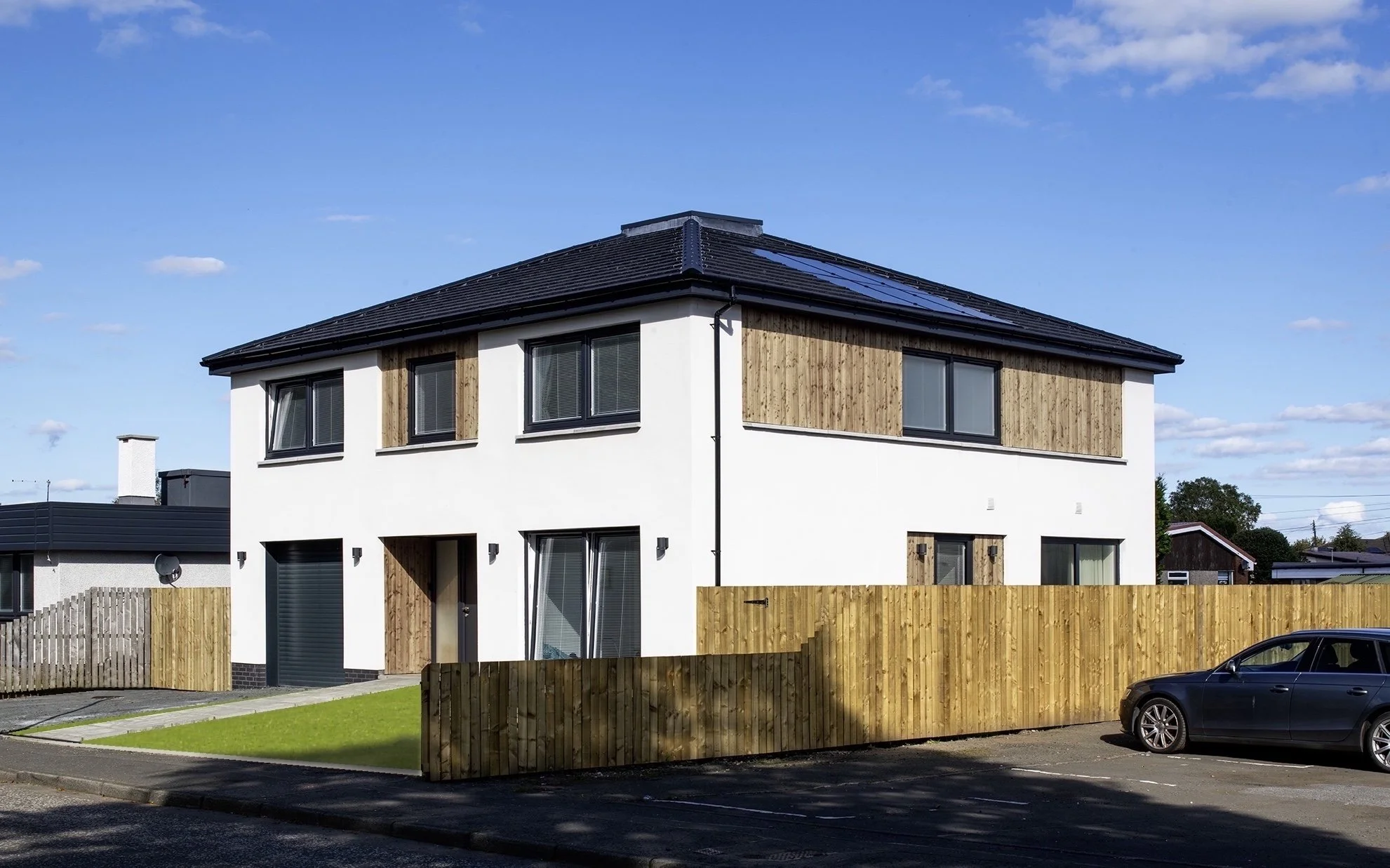 The square plan house is a strong simple design that sits well in a varied context.