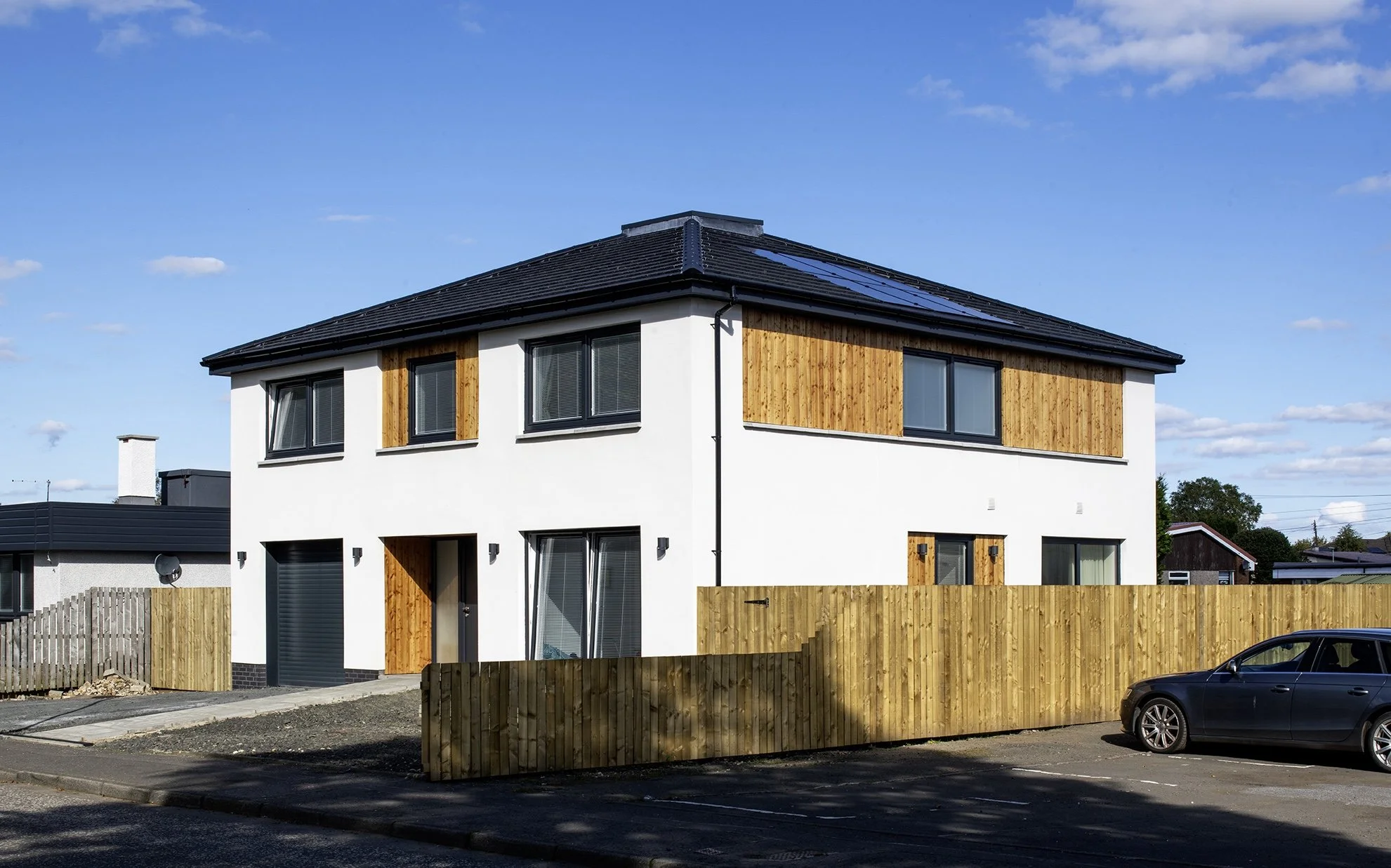 The square plan house is a strong simple design that stands well in a varied context.