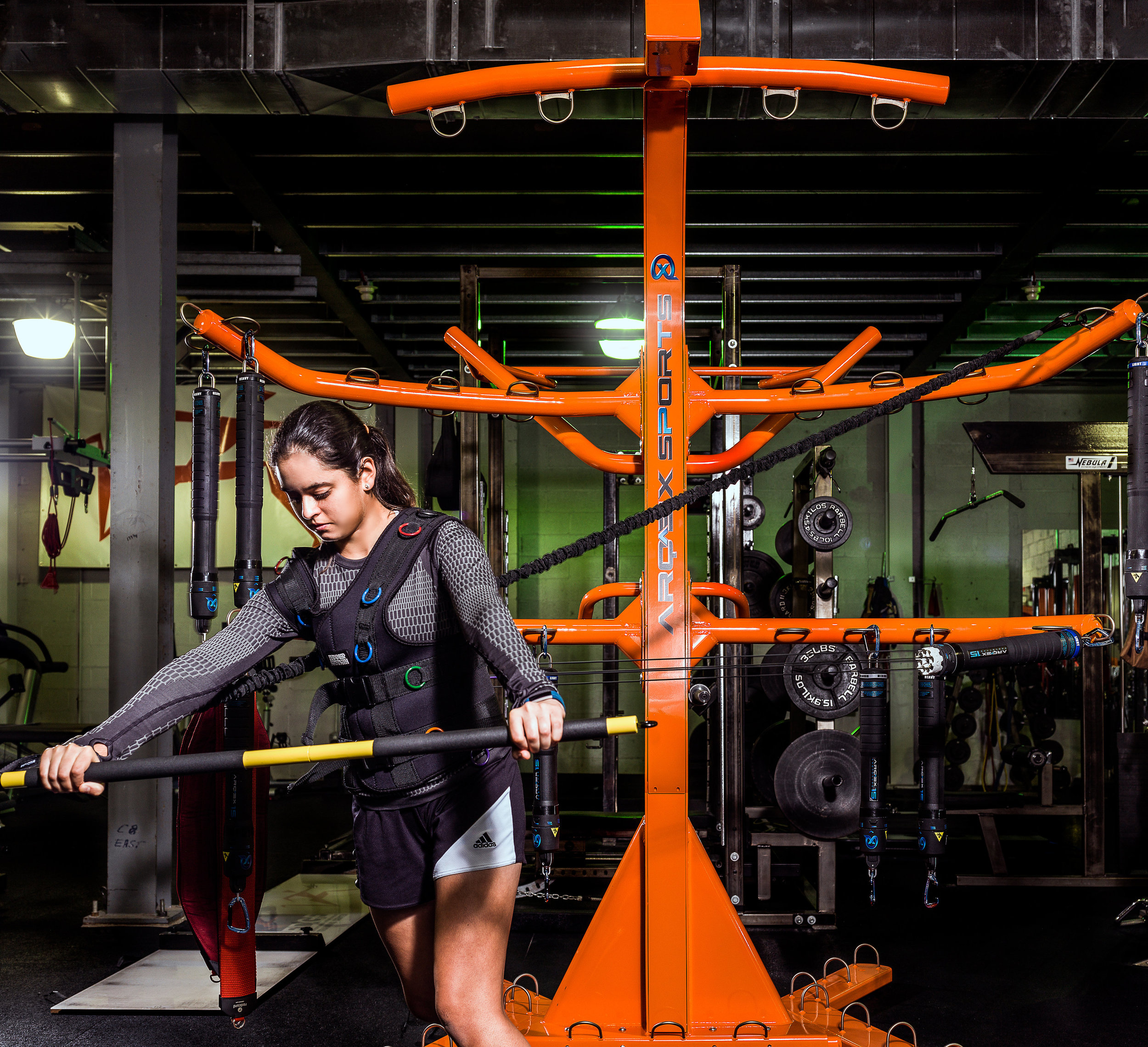 BSG Junior performing a pushing exercise on the Arqex fitness machine