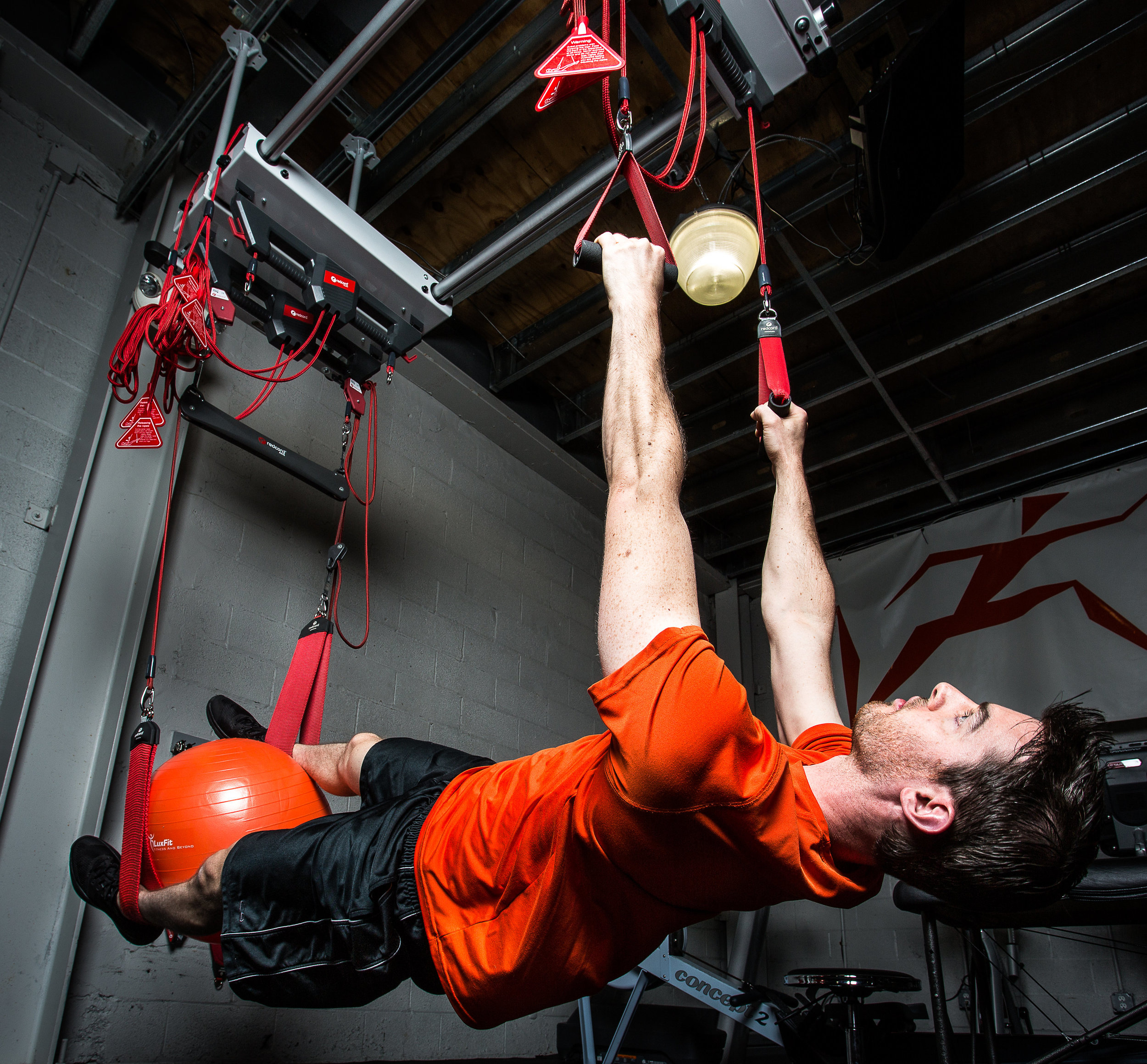 Athlete working on rotary stability on Redcord system