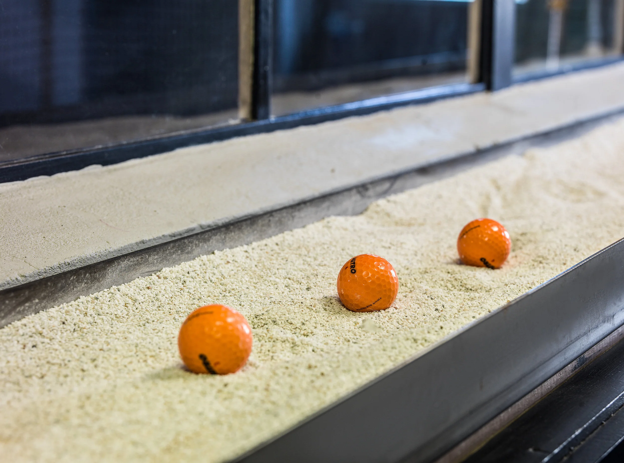 Orange golf balls display by entrance of BenShearGolf studio