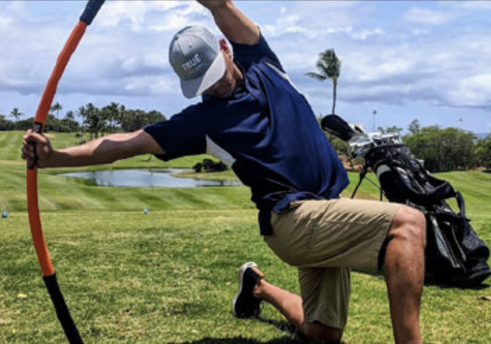 Athlete Performing Side Bend Stretch On One Knee With Mobility Stick