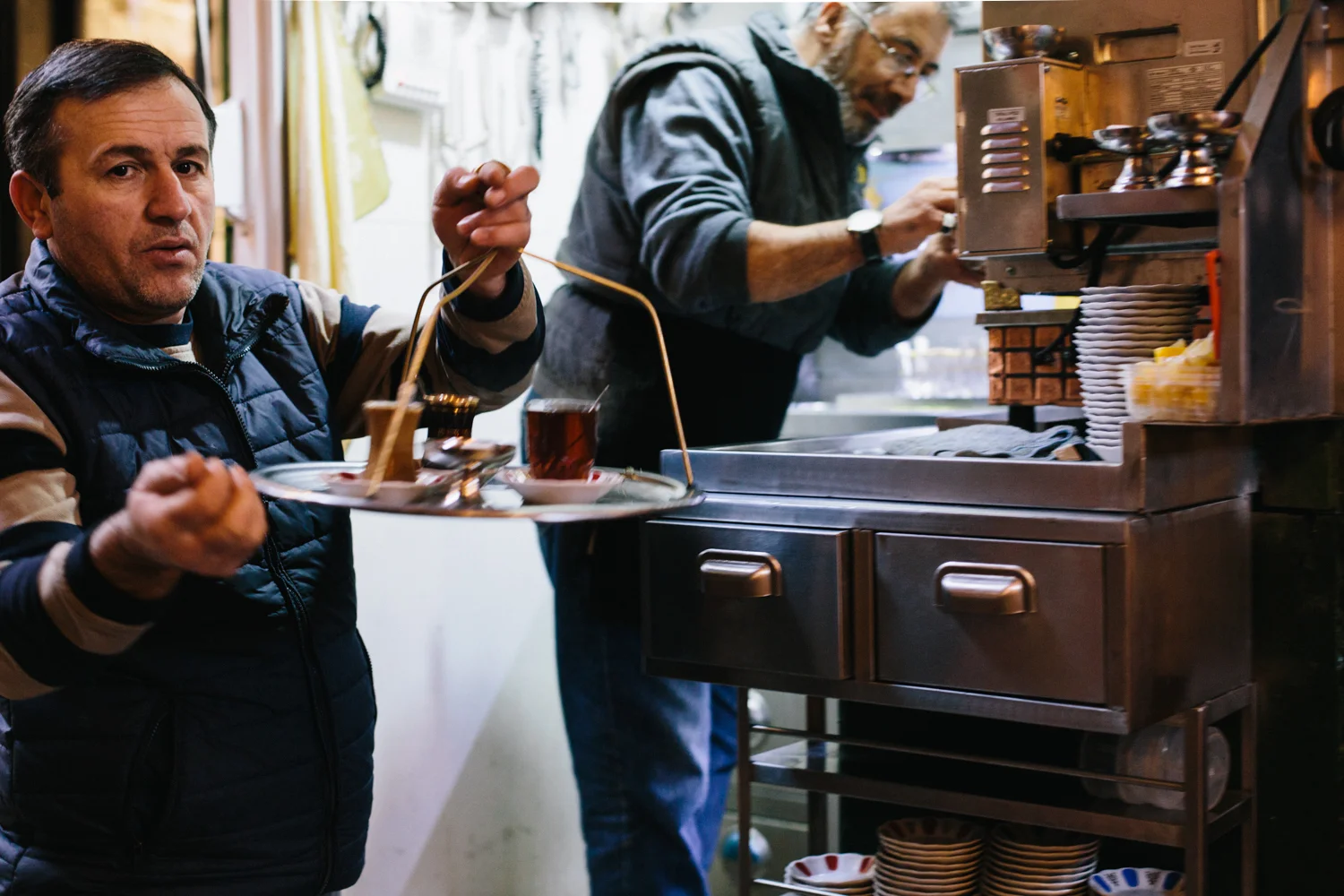 In the Grand Bazaar tea flows in waves. It's served strong and black, in hourglass-shaped glasses, beside sugar cubes and a small spoon.