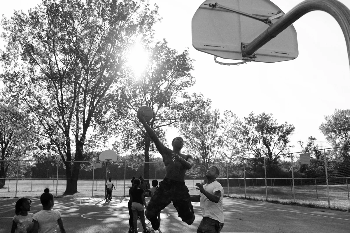  Kids are seen playing a pick-up game of basketball at one of the only parks in Dolton, a south suburb of the city of Chicago,&nbsp;on a summer evening in August 2016.&nbsp; 