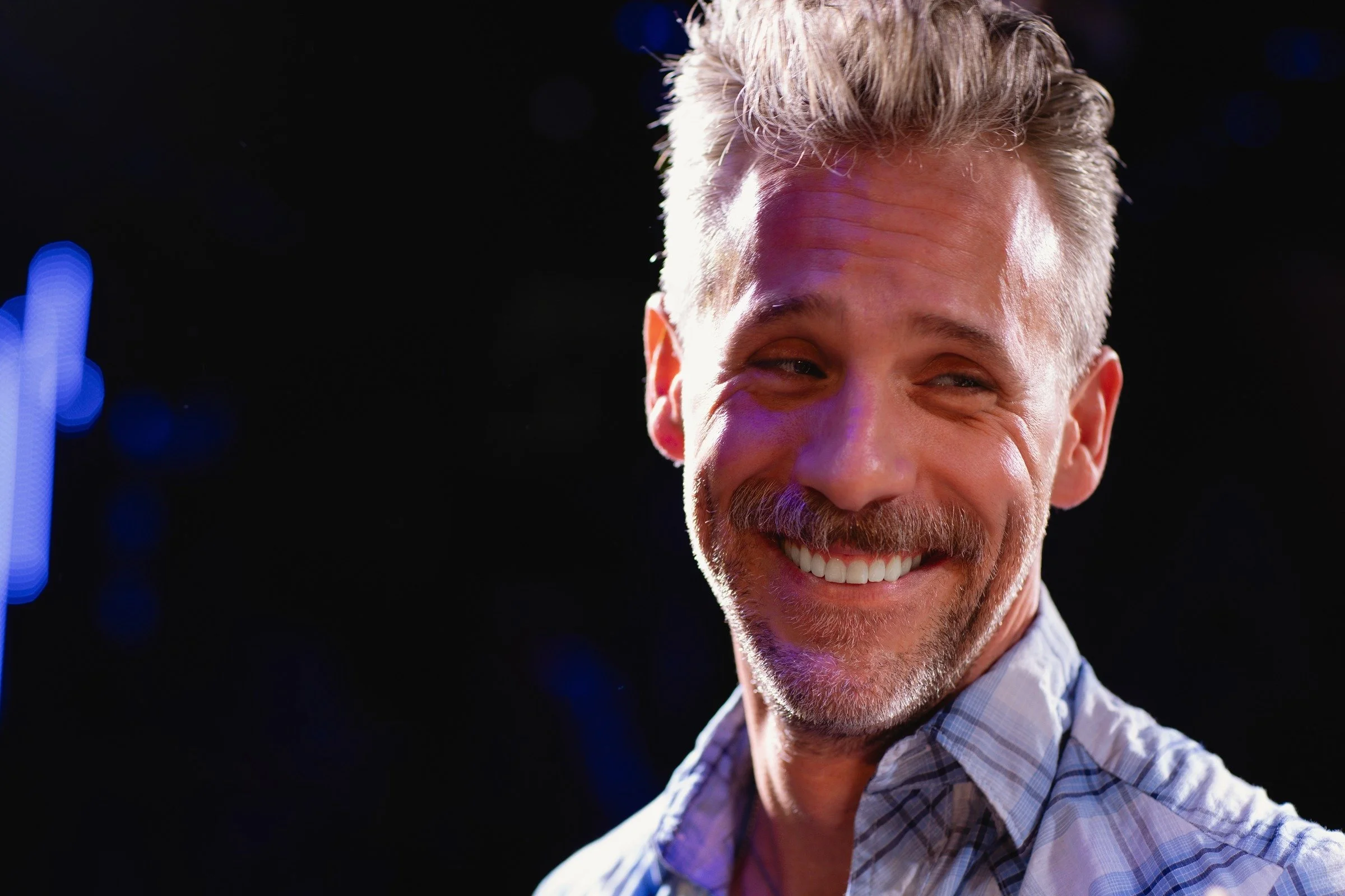 Craig Klonowski smiling after a live performance at The Duplex in New York.