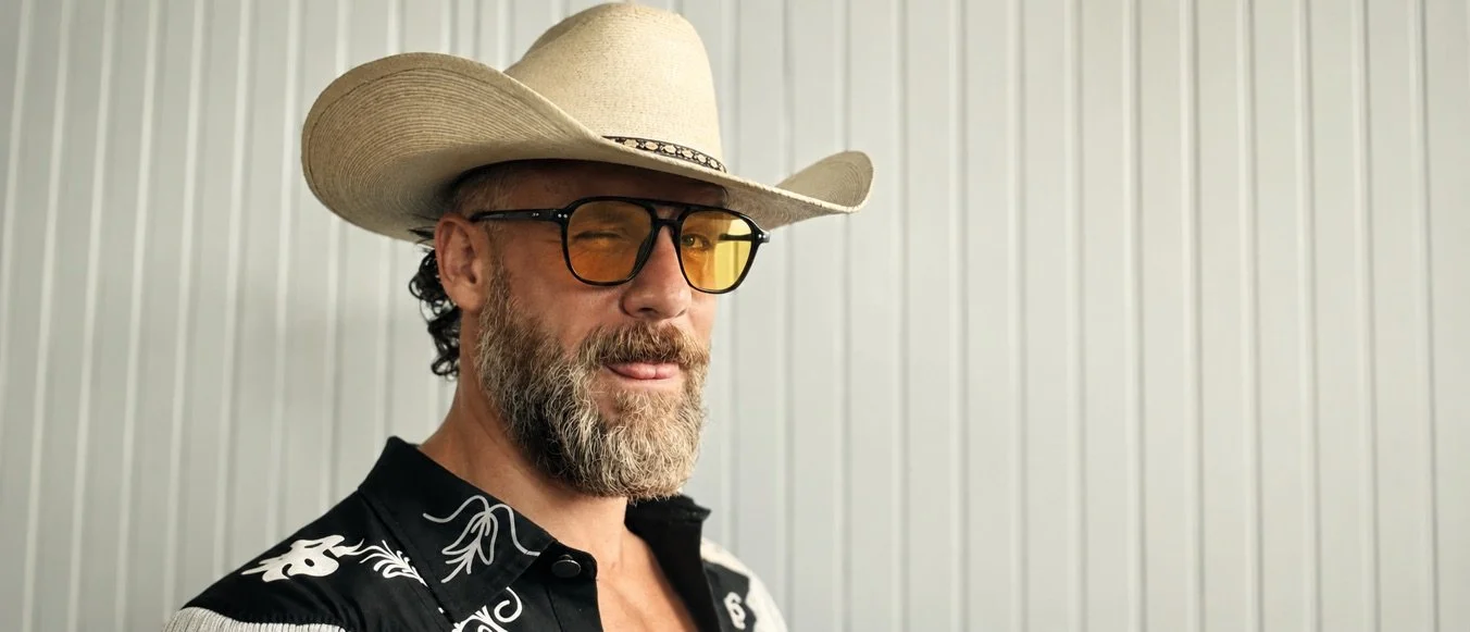 Craig Klonowski in a cream cowboy hat and amber glasses.