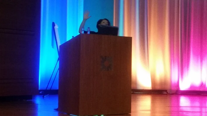 On stage behind lectern at RBS