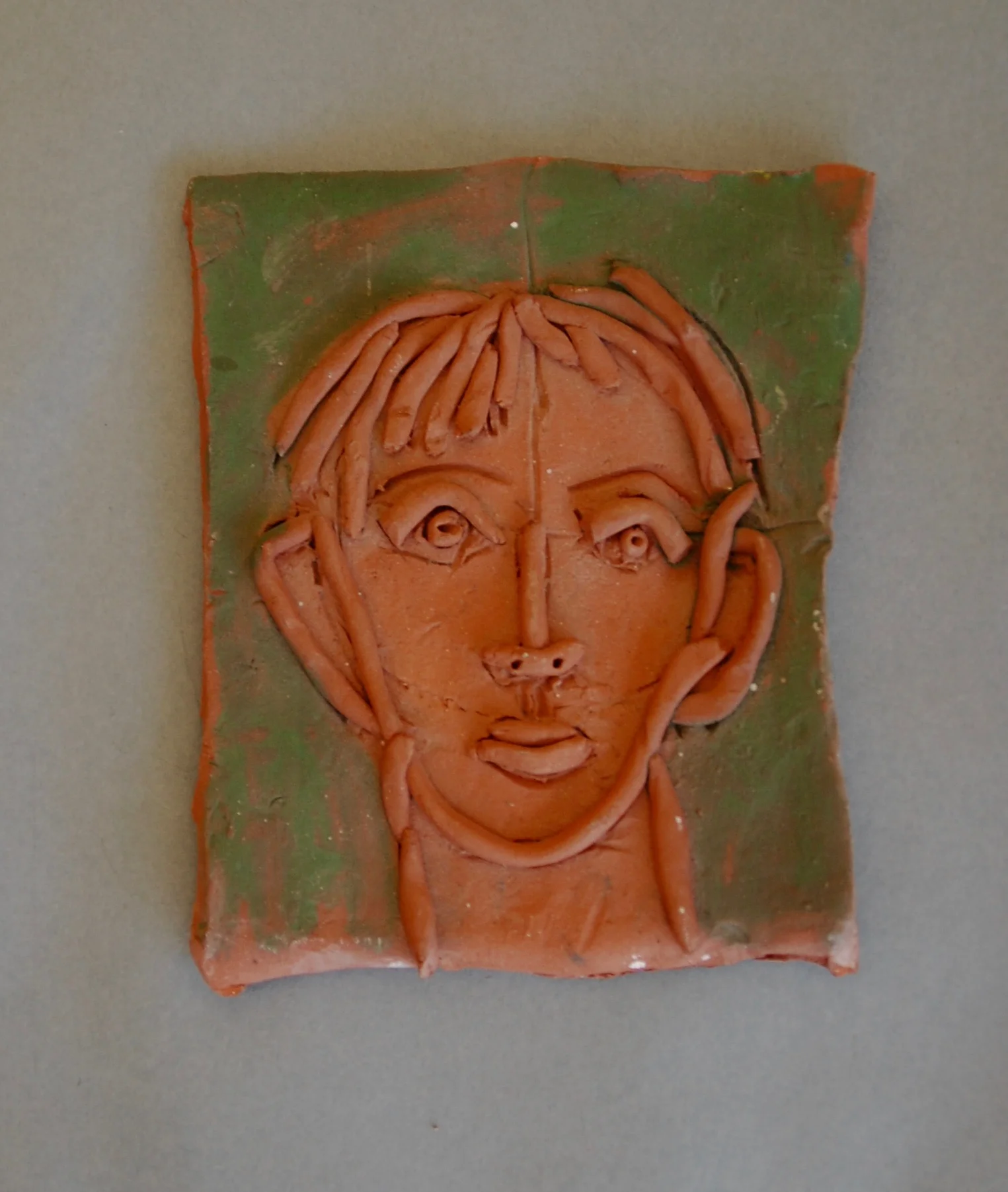 Small tile, head of a man with coils.jpg