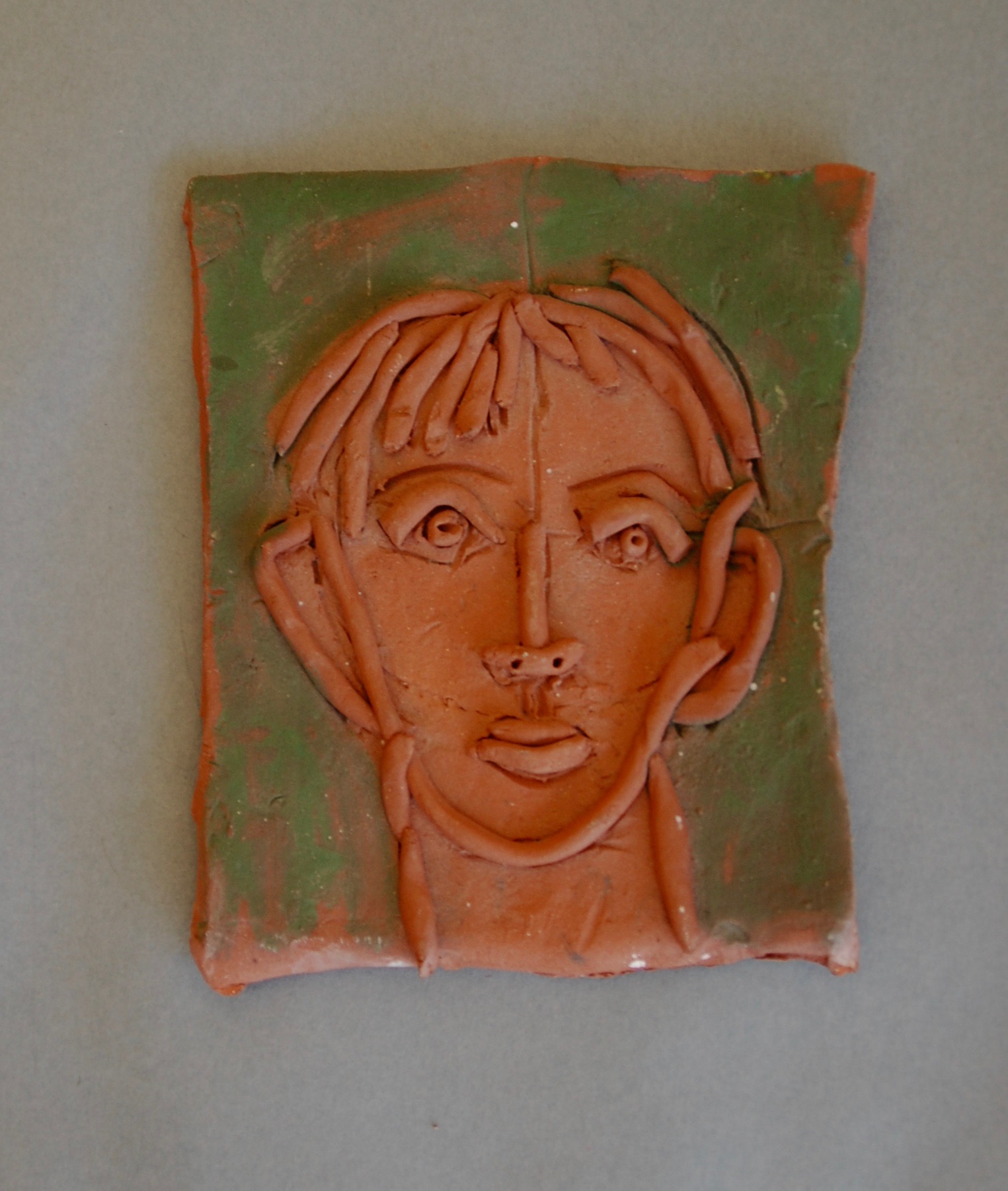 Small tile - head of a man with coils, 1997
