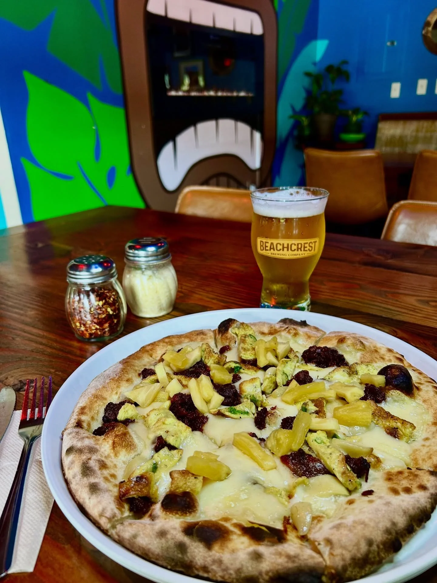 The June Pizza of the Month is 🔥! 

Meet the Pork Tocino Pizza- Filipino red pork, roasted garlic, scallion omelet &amp; Gruyere cheese finished with pickled pineapple.  Pair it with a pint of our newest release the Beachcrest Pils, a crisp traditio
