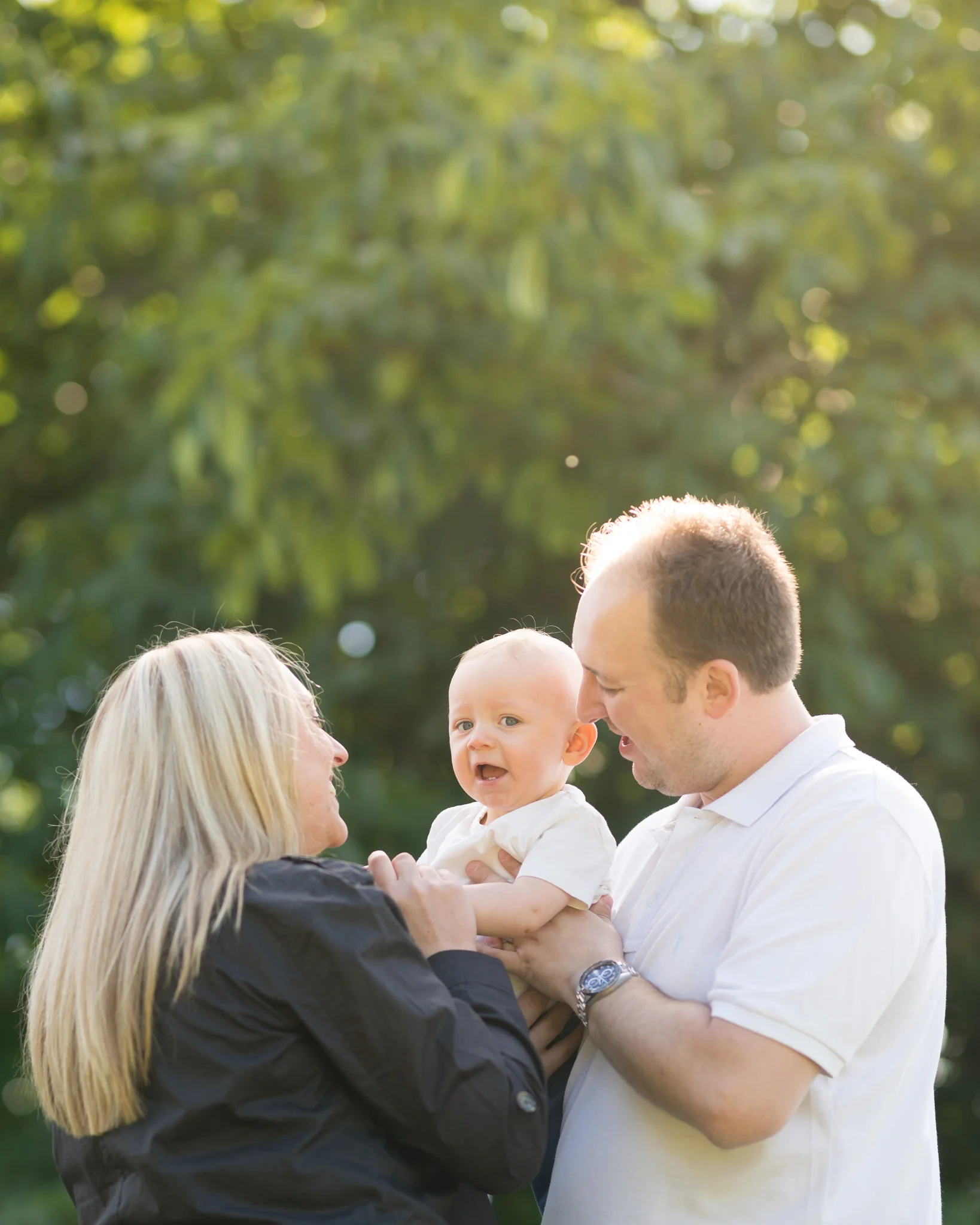 Parents laughing with young son in park | Warwickshire Family Photographer