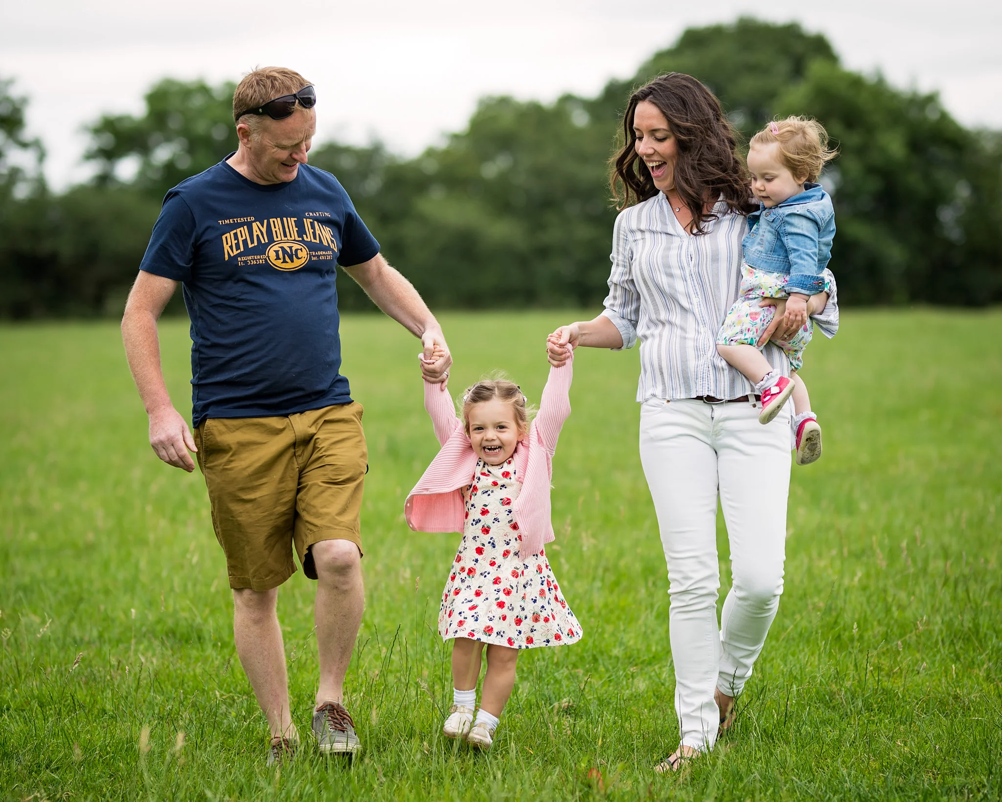 Swinging daughter between parents | Warwickshire Family Photographer