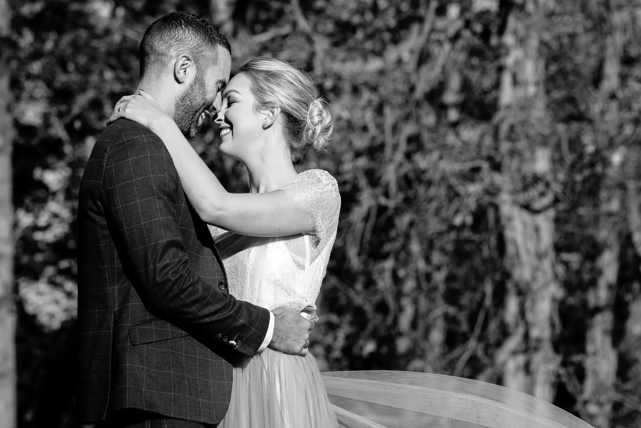 Black and white of bride and groom holding and smiling | Warwickshire Wedding Photographer