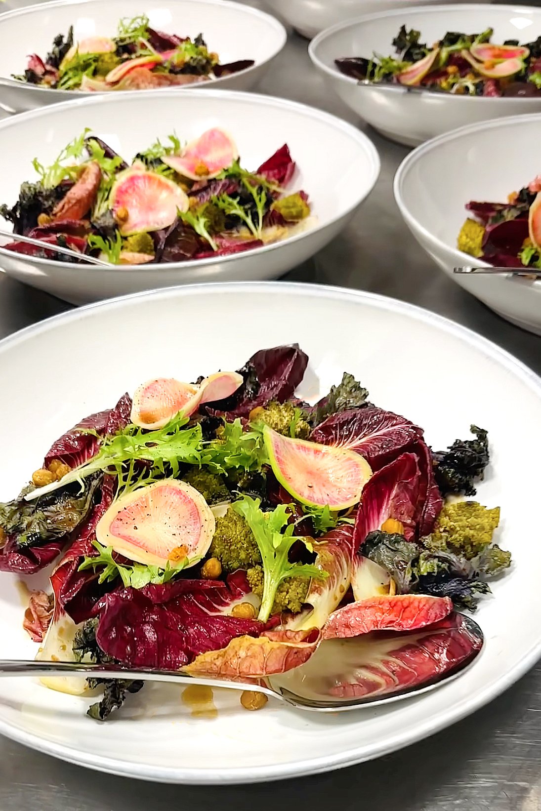 Colorful plated dish of roasted Romanesco, radicchio, kale, watermelon radish, and crispy chickpeas, created by Cava & Cake for the Milk Makeup x Ulta dinner in Los Angeles.