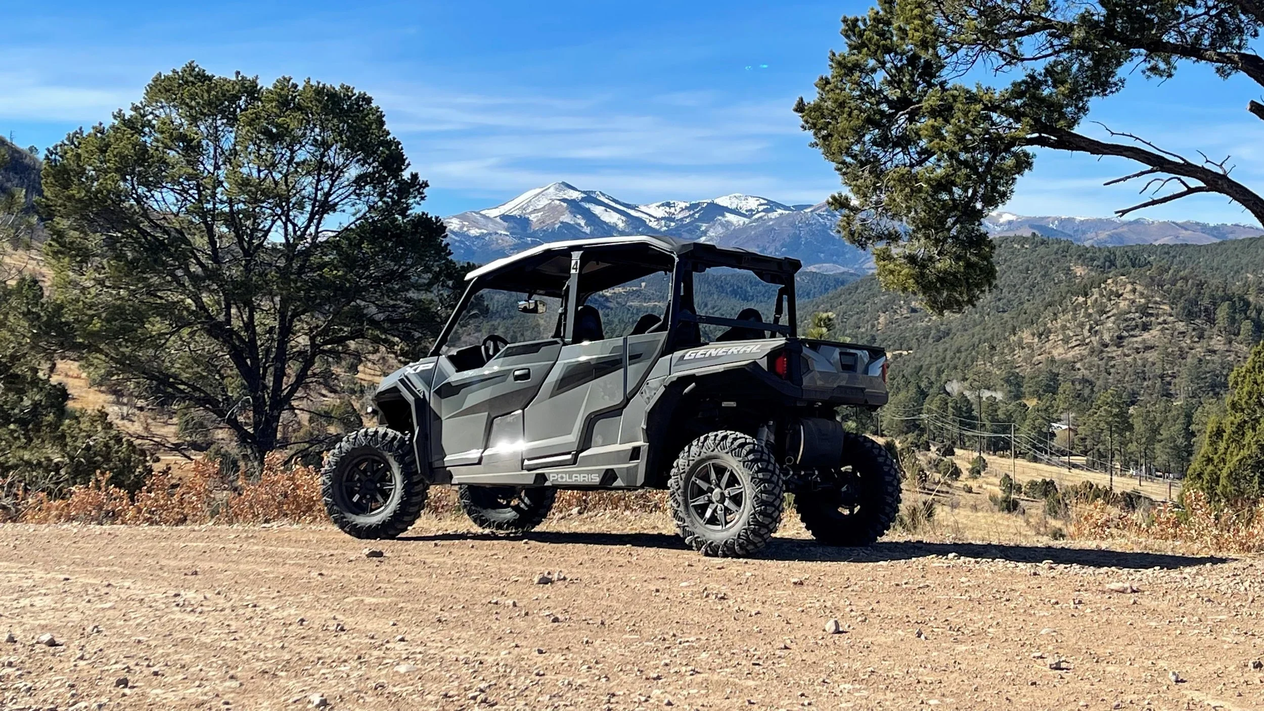 Photograph of off-road Backcountry Attitudes OHV with snow-covered Sierra Blanca peak in the background