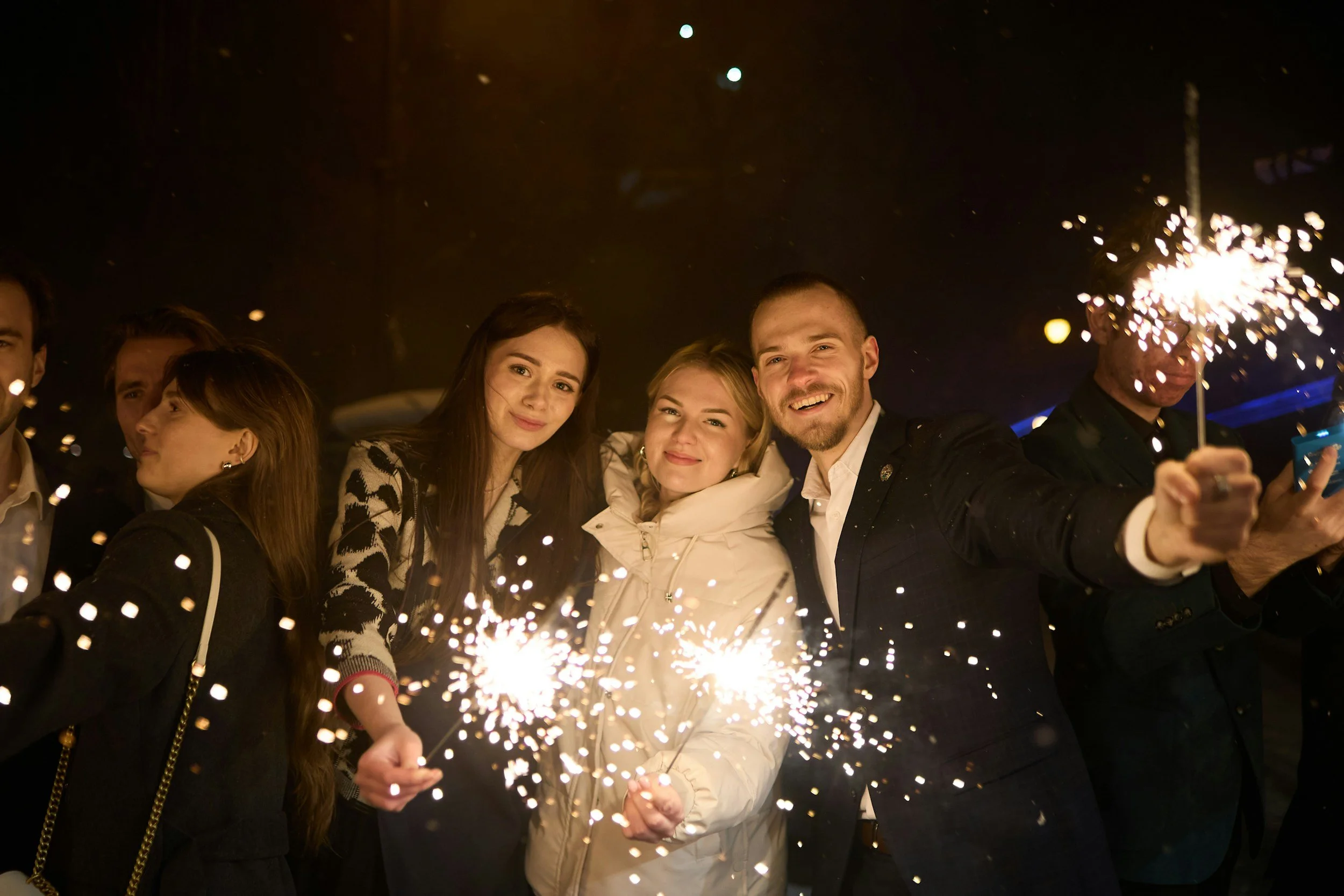 Photograph of party goers with sparklers celebrating New Year's Eve.