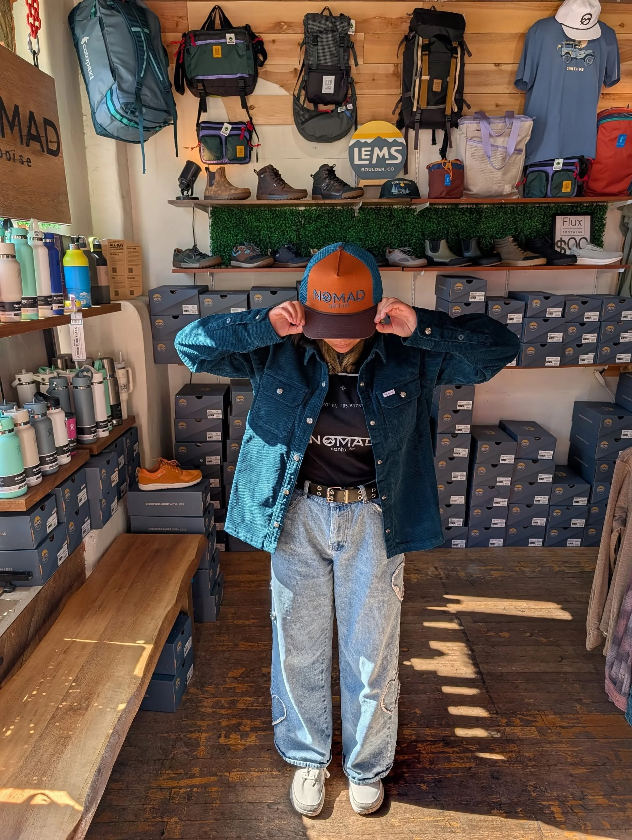  Shopper browsing outdoor apparel and gear at NOMAD in Ruidoso 
