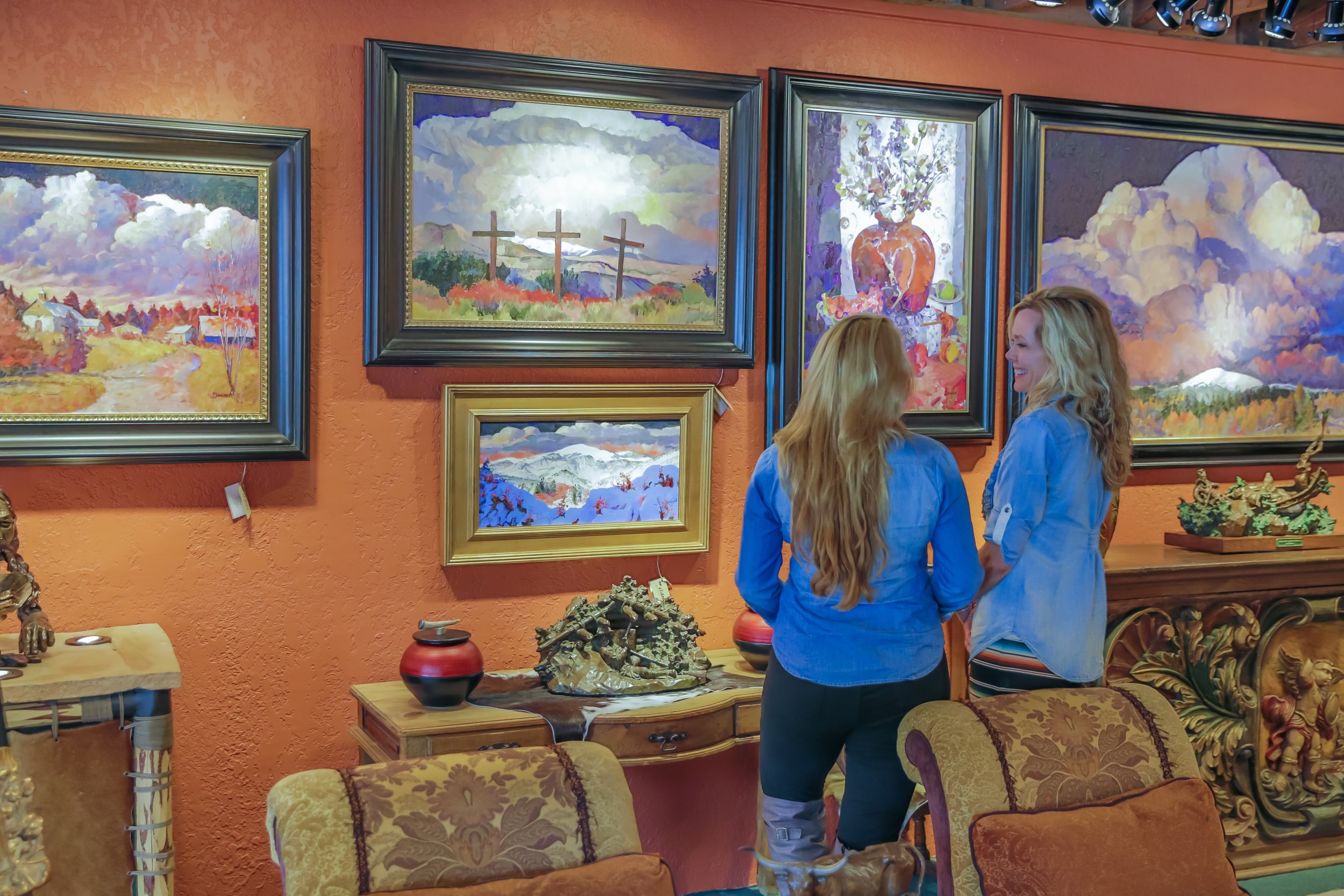 Visitors viewing contemporary Southwestern artwork at The Adobe Fine Art gallery.