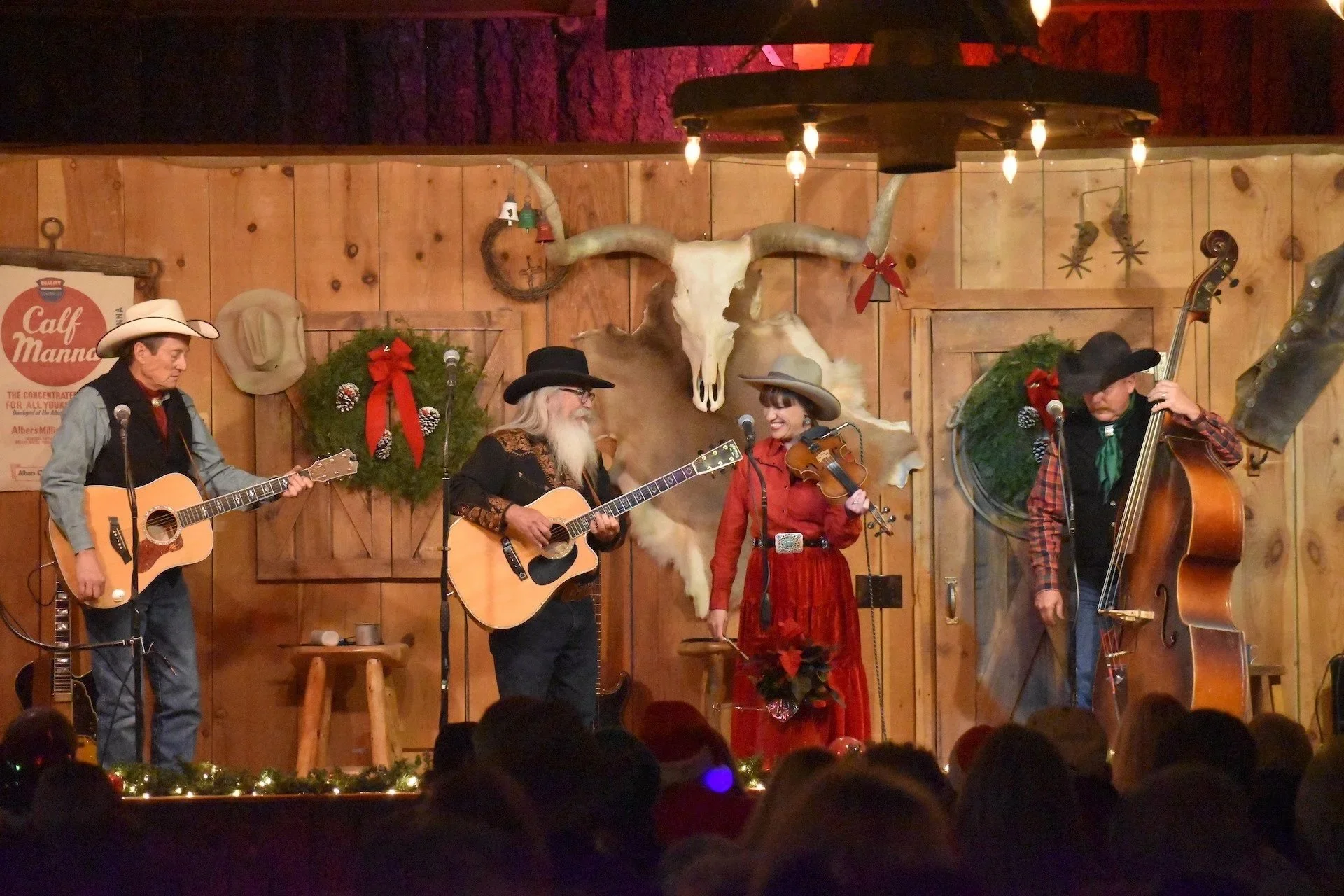 Photograph of the Flying J Wranglers performing their White Mountain Christmas show on stage at the Flying J Ranch in Alto, NM