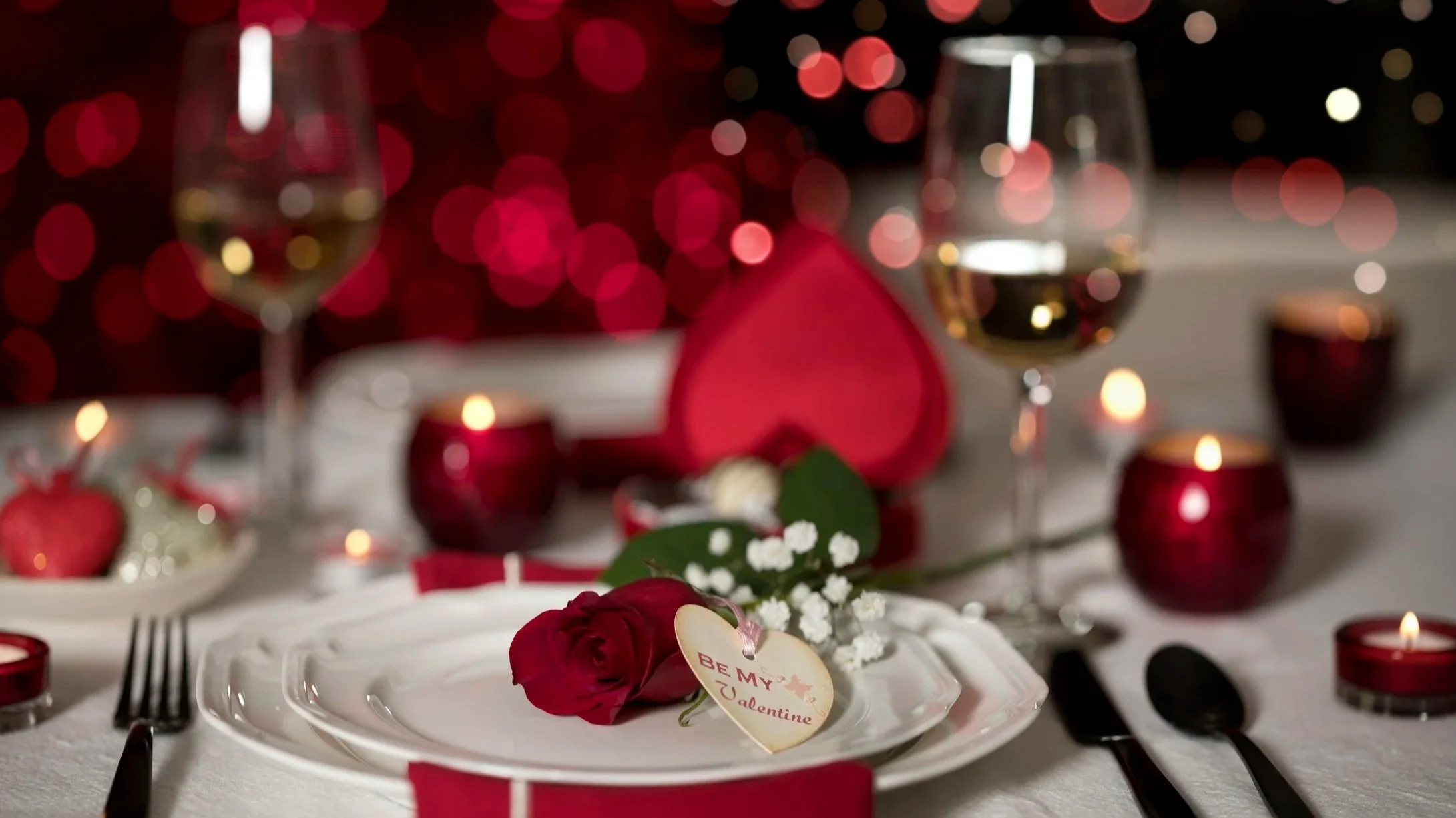 Photograph of restaurant dining table set with roses and candles for Valentine's Day dining