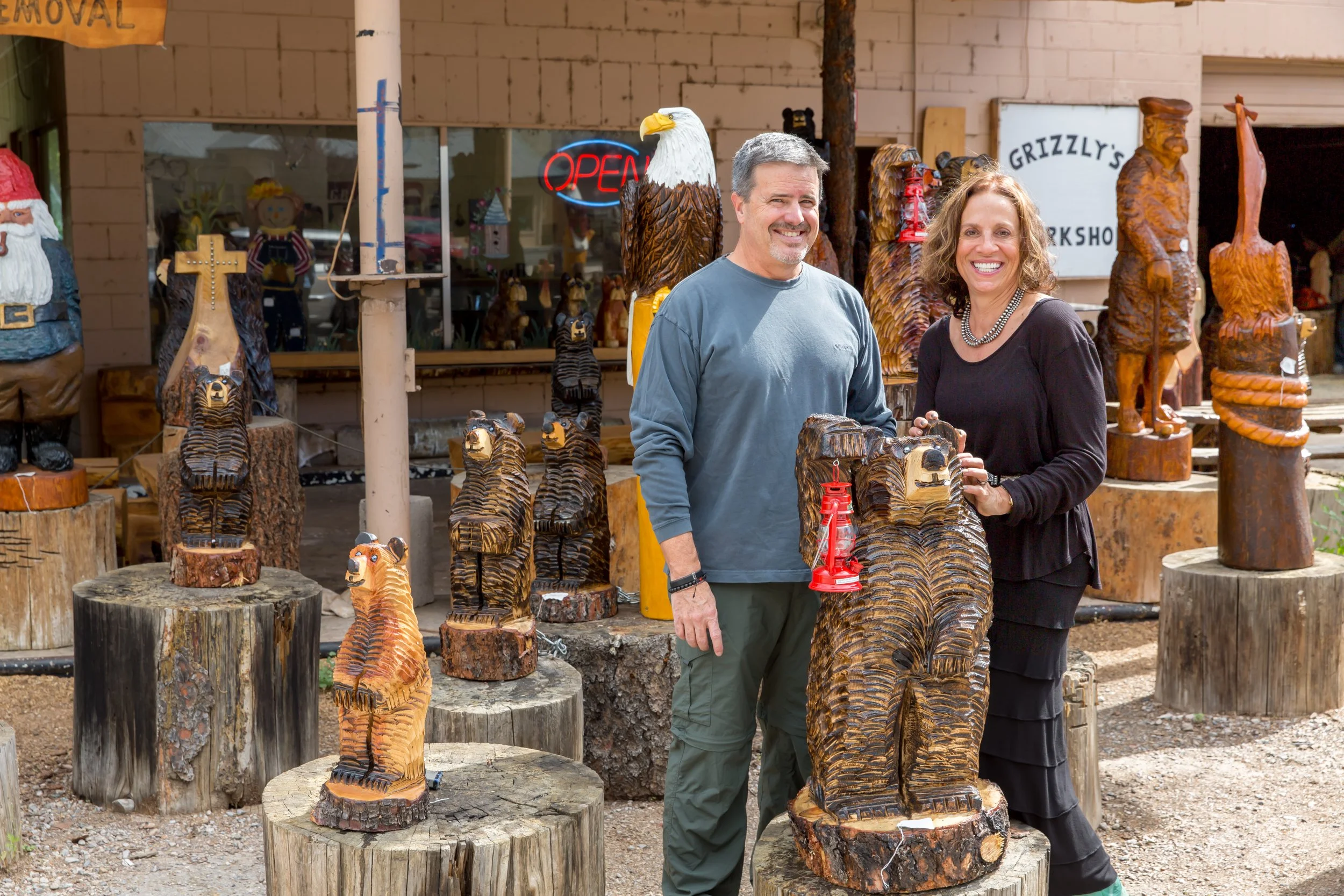 Visitors with hand-carved wooden bear sculptures outside Grizzly’s Bears in Ruidoso.