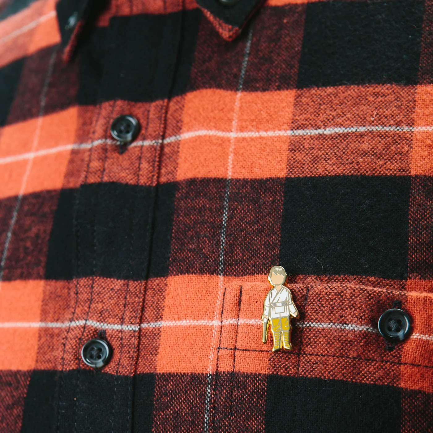Farm Boy Action pin paired with red buffalo plaid.