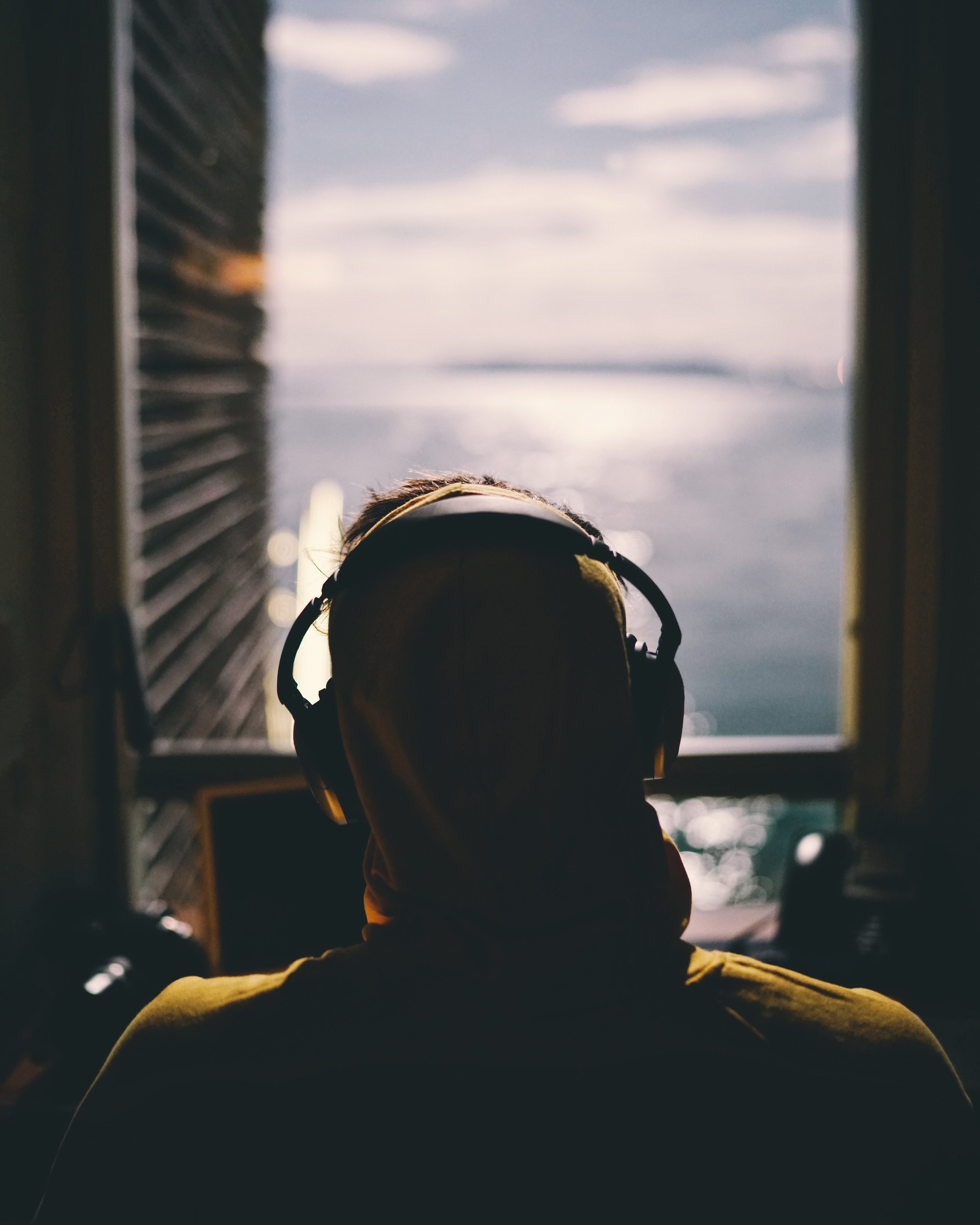 Man earphones looking out window © Reynier Carl.jpg