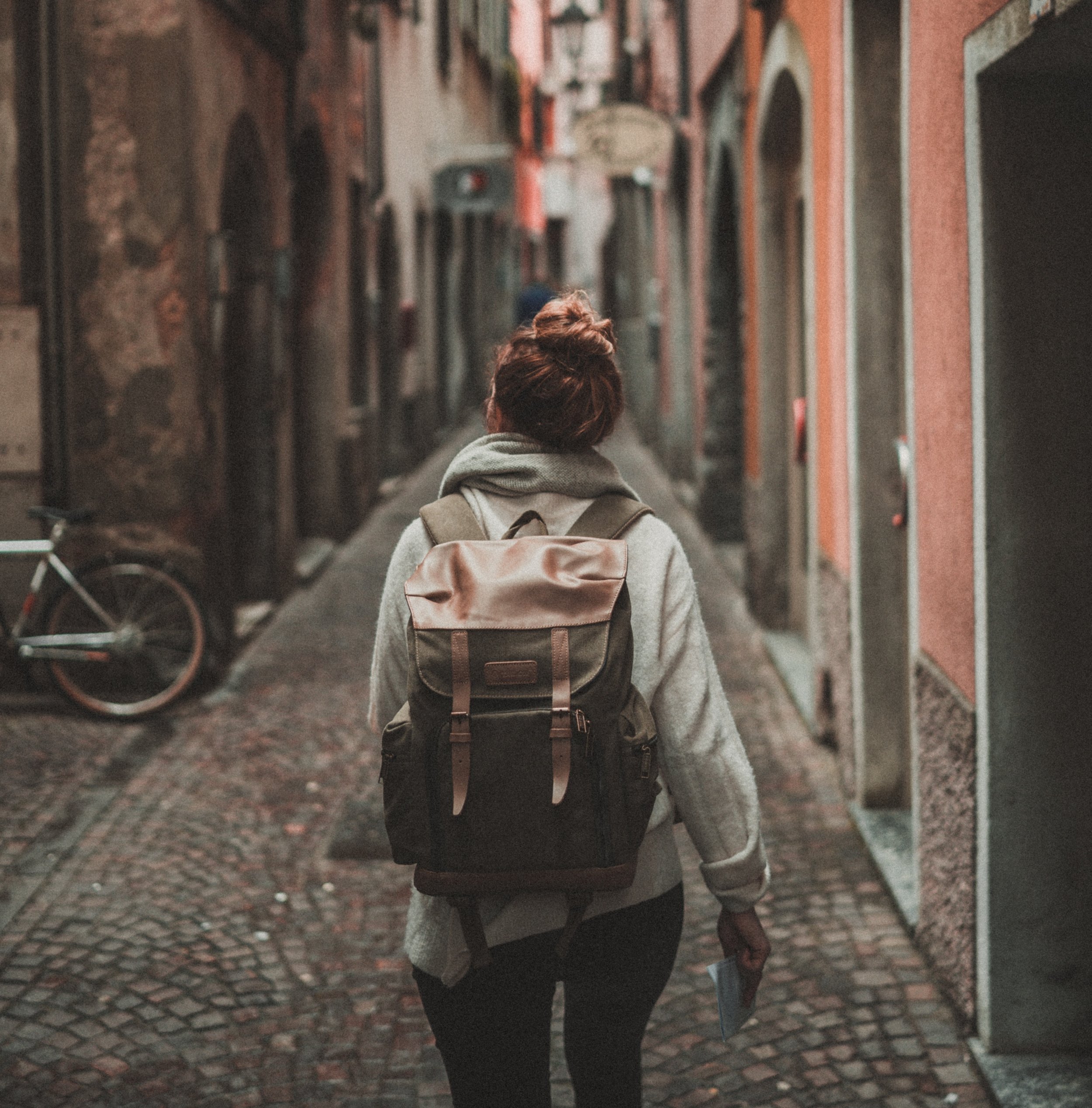 Girl with backpack on narrow European street © Timo Stern, cropped.jpg