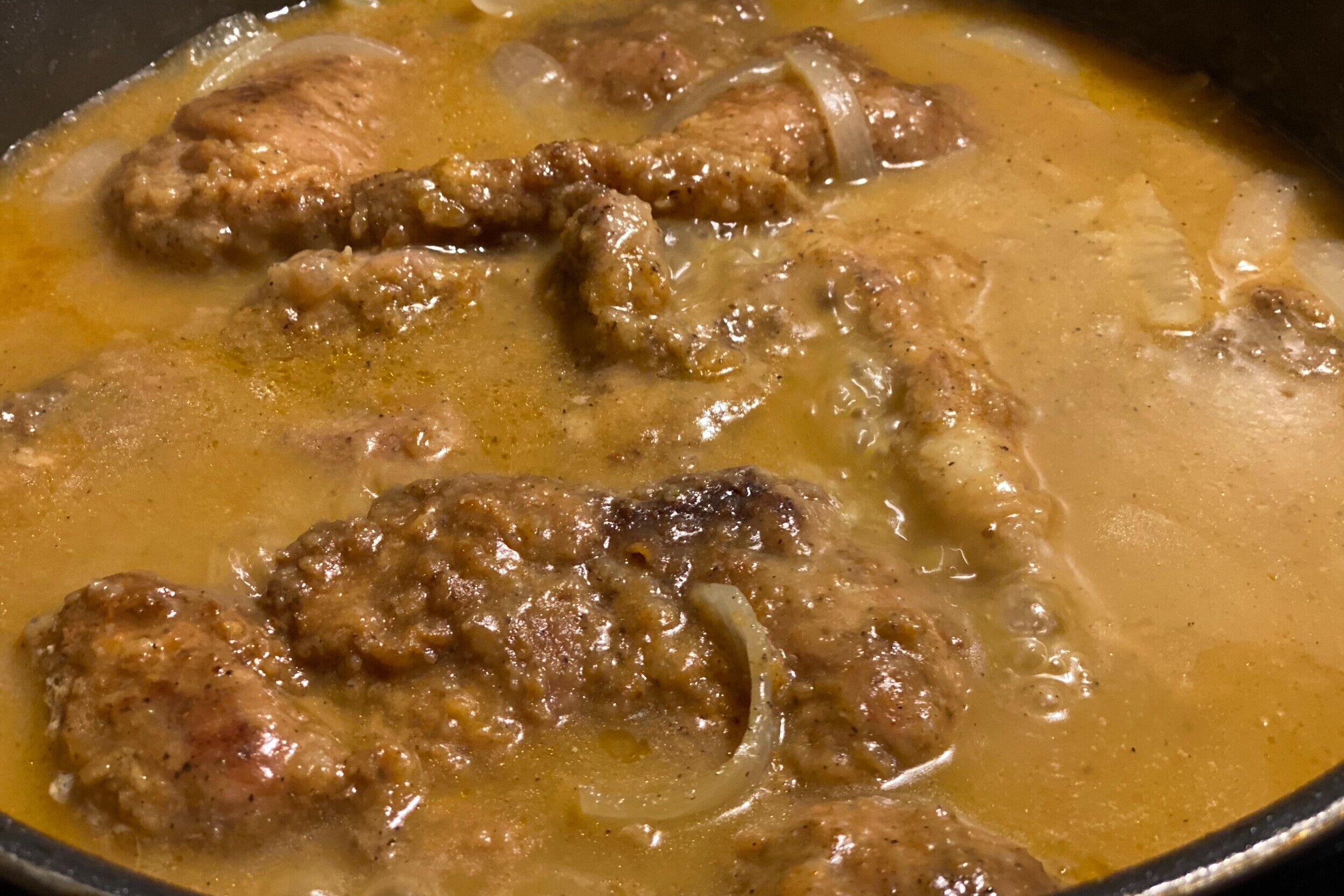  Smothered pork shoulder steaks in gravy 