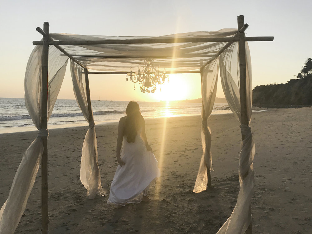  bride on Santa Barbara beach under wedding chuppah 