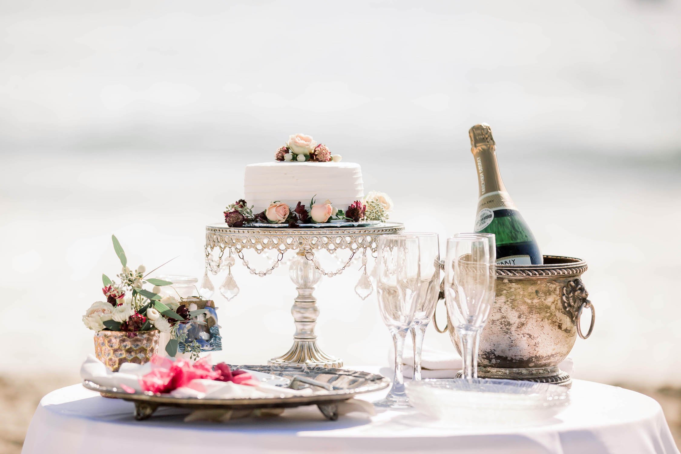 wedding elopement cake and champagne on the beach