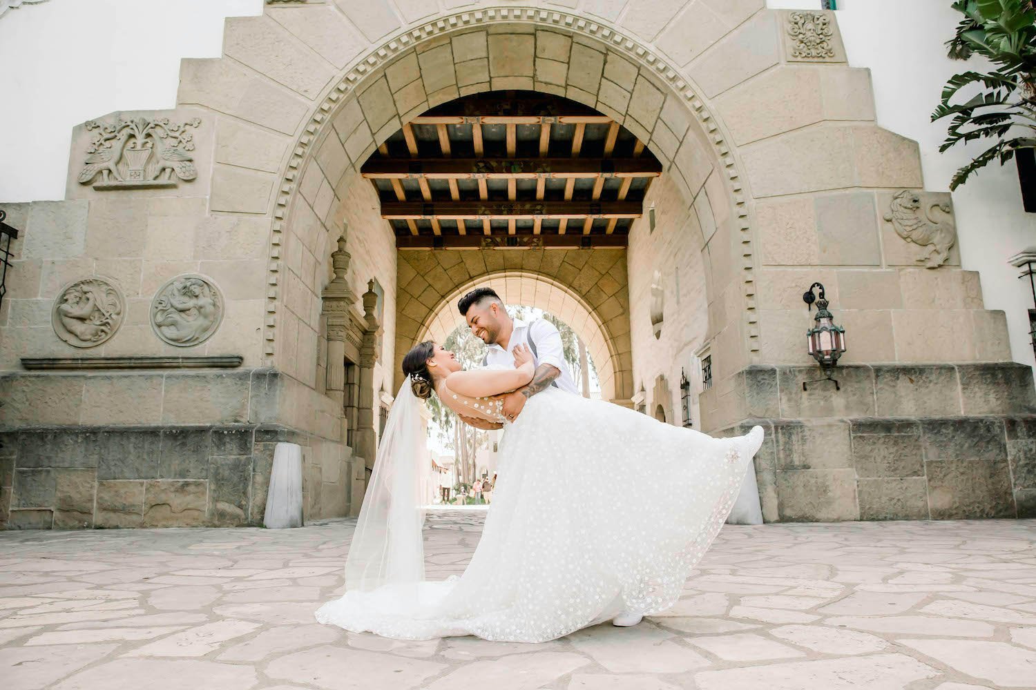  groom dips bride in front of Santa Barbara county Courthouse 