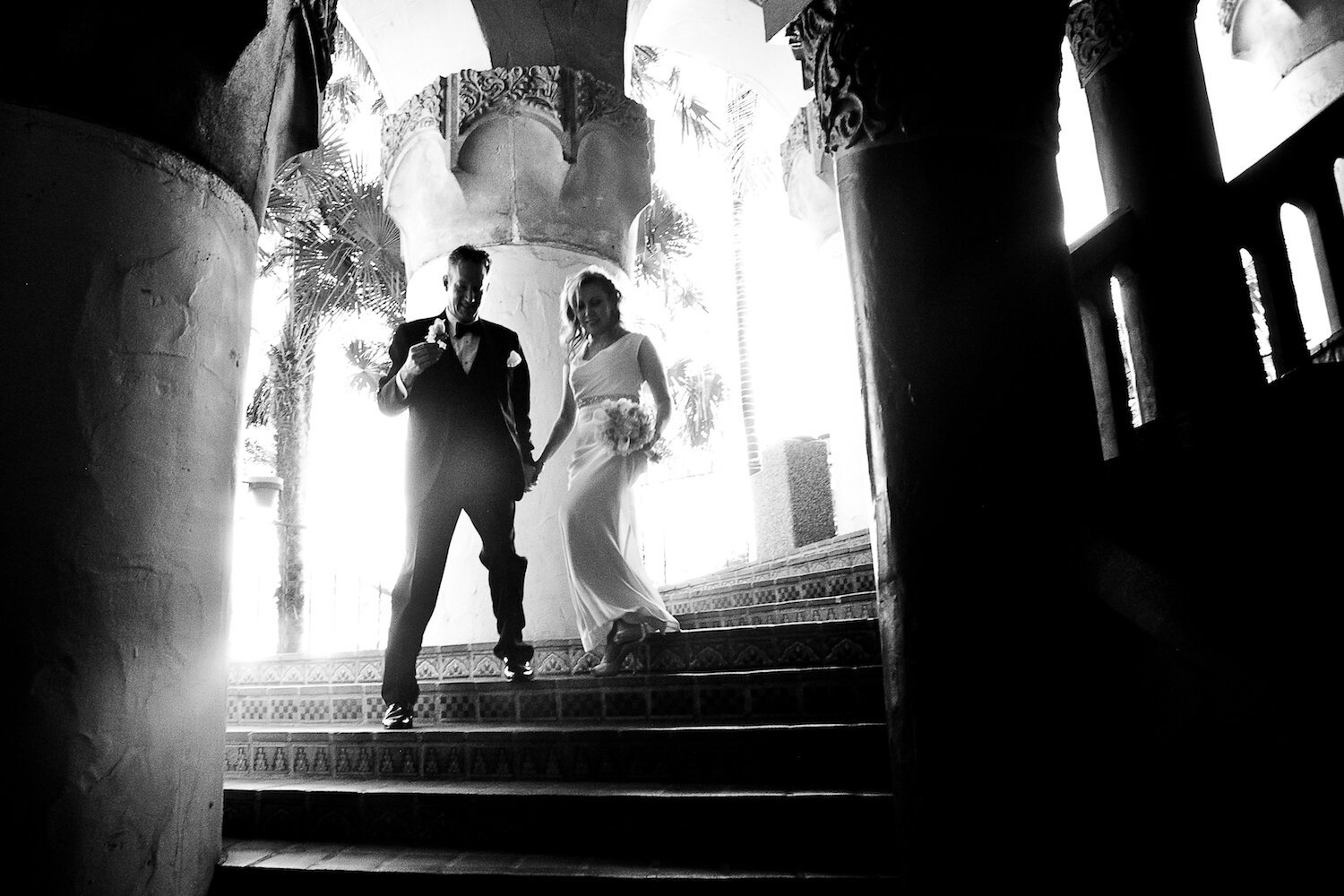 black and white photo of couple walking down stairs at SB Courthouse