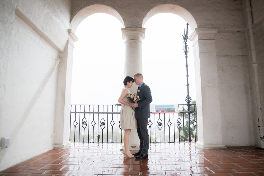 bride and groom hold hands while standing inside courthouse in Santa Barbara