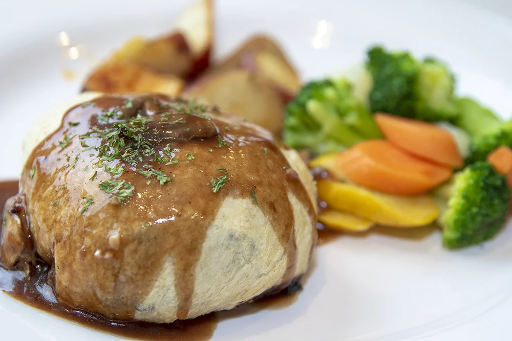 Filet Mignon wrapped in puff pastry and topped with mushroom sauce.