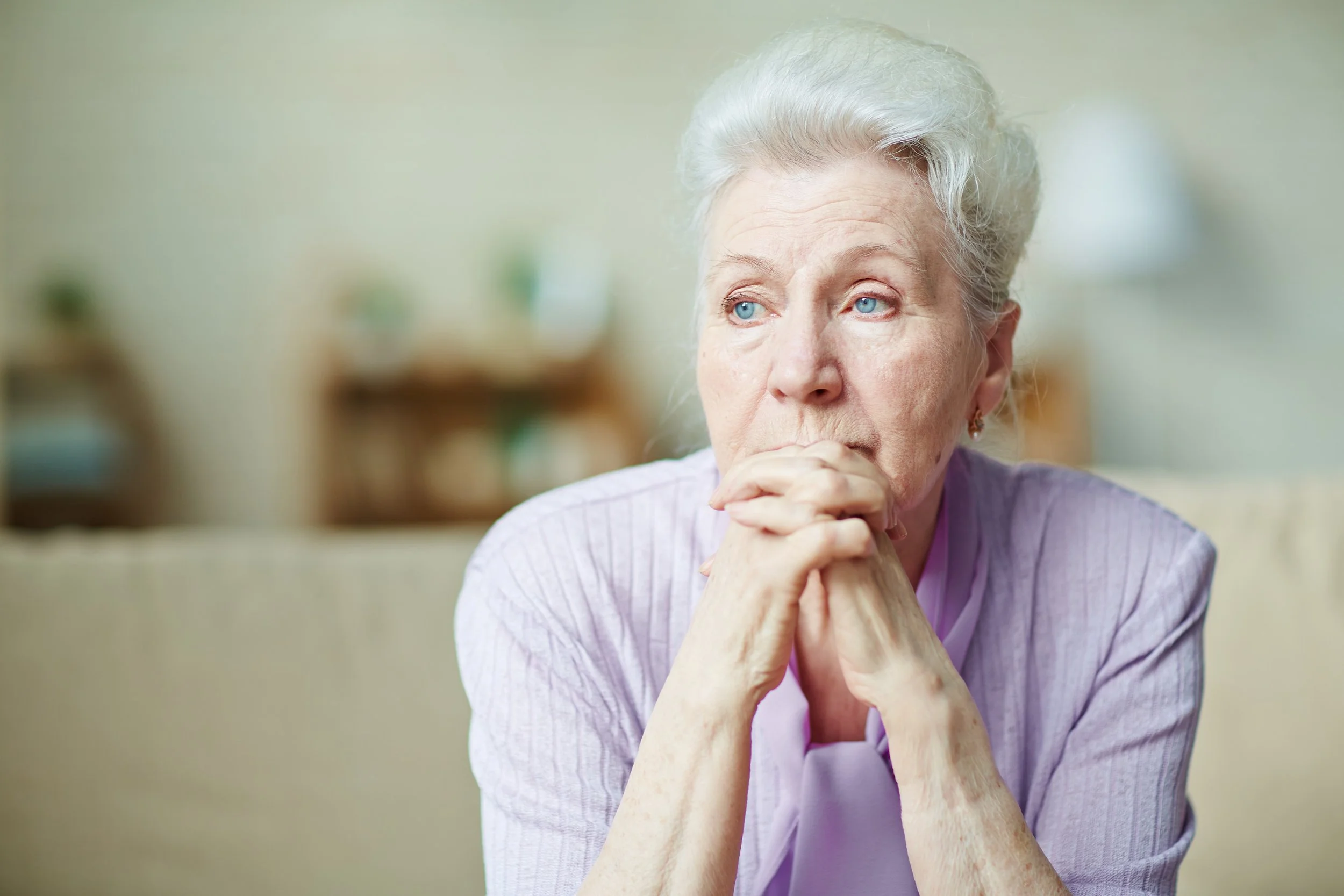 Elderly woman in a purple sweater