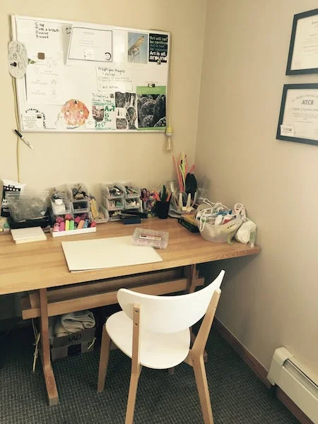 Valerie's art making desk with whiteboard above.