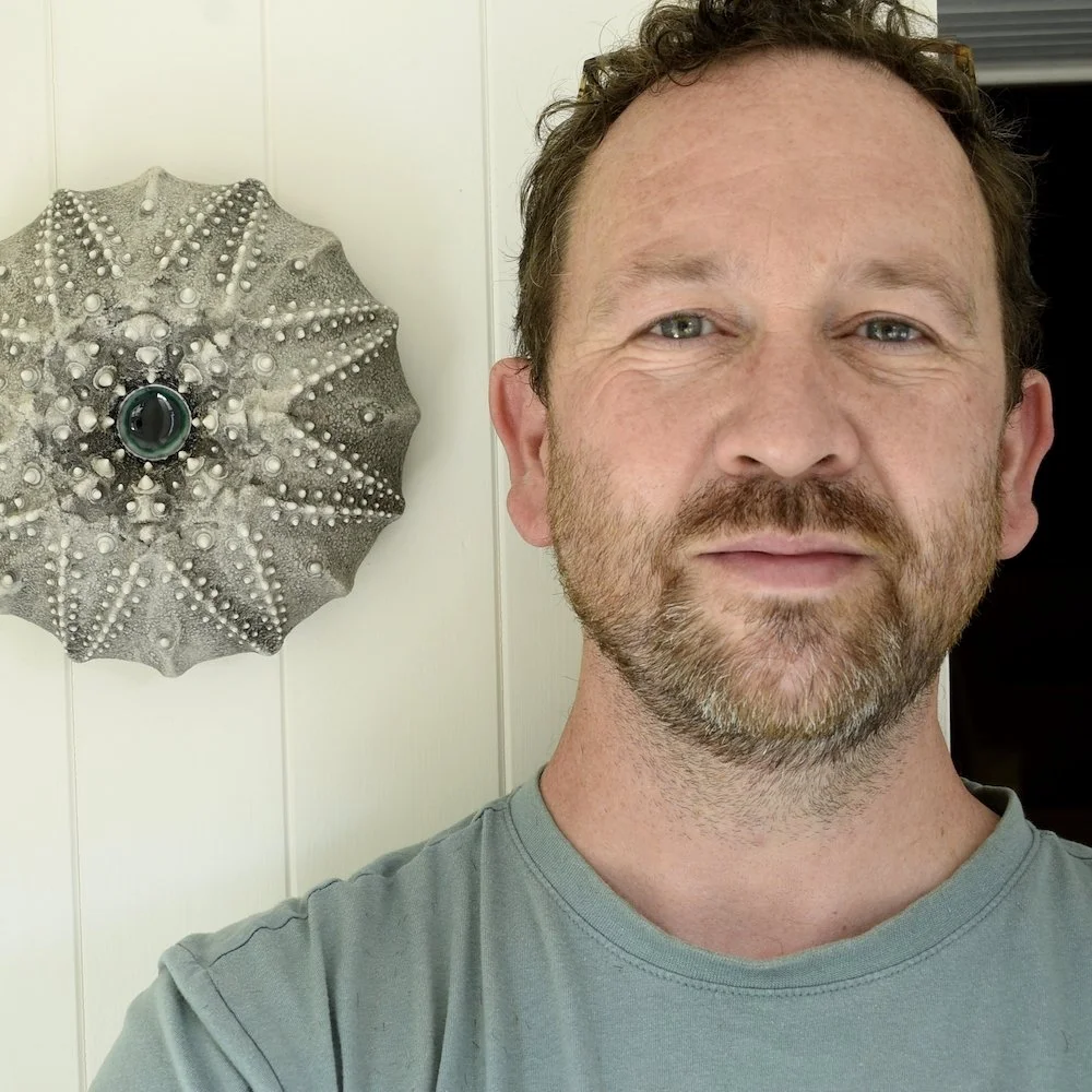 photograph of the artist standing with his Porcelain Ceramic Wall sculpture Art by Irish Ceramic Artist Darren Francis Cassidy