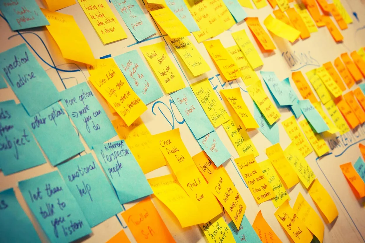 a-bunch-of-post-it-notes-regarding-affordable-web-design-on-a-white-board.jpg